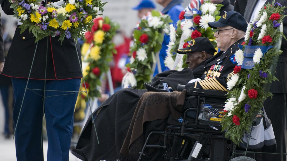 Edward Davis, right, a 94-year-old Army veteran who witnessed the Japanese sneak attack on Hawaii, and Frank Levingston, a 110-year-old Army veteran believed to be the nation’s oldest living World War II veteran, attend a Pearl Harbor remembrance ceremony at the National World War II Memorial on Dec. 7, 2015, in Washington, D.C. The attacks on the island of Oahu eventually left more than 2,400 dead and almost 1,200 wounded as it catapulted the U.S. into the war.