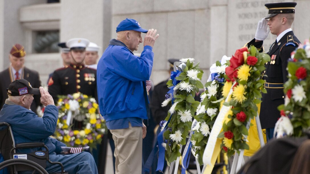 Two World War II veterans render a salute after laying a wreath during a Pearl Harbor remembrance ceremony at the National WWII Memorial on Dec. 7, 2015, in Washington, D.C. The attacks on the island of Oahu eventually left more than 2,400 dead and almost 1,200 wounded as it catapulted the U.S. into the war.
