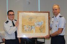 Col. John Savage and Lt. Gen. Mark Ediger display Ms. Judy Blomquist’s painting which depicts AFMS medics in Afghanistan rendering aid after a bombing. The painting was presentedat a ceremony at the DHHQ in Falls Church, Va., on Nov. 27..
Credit: U.S. Air Force by Mr. Tony Joyner

