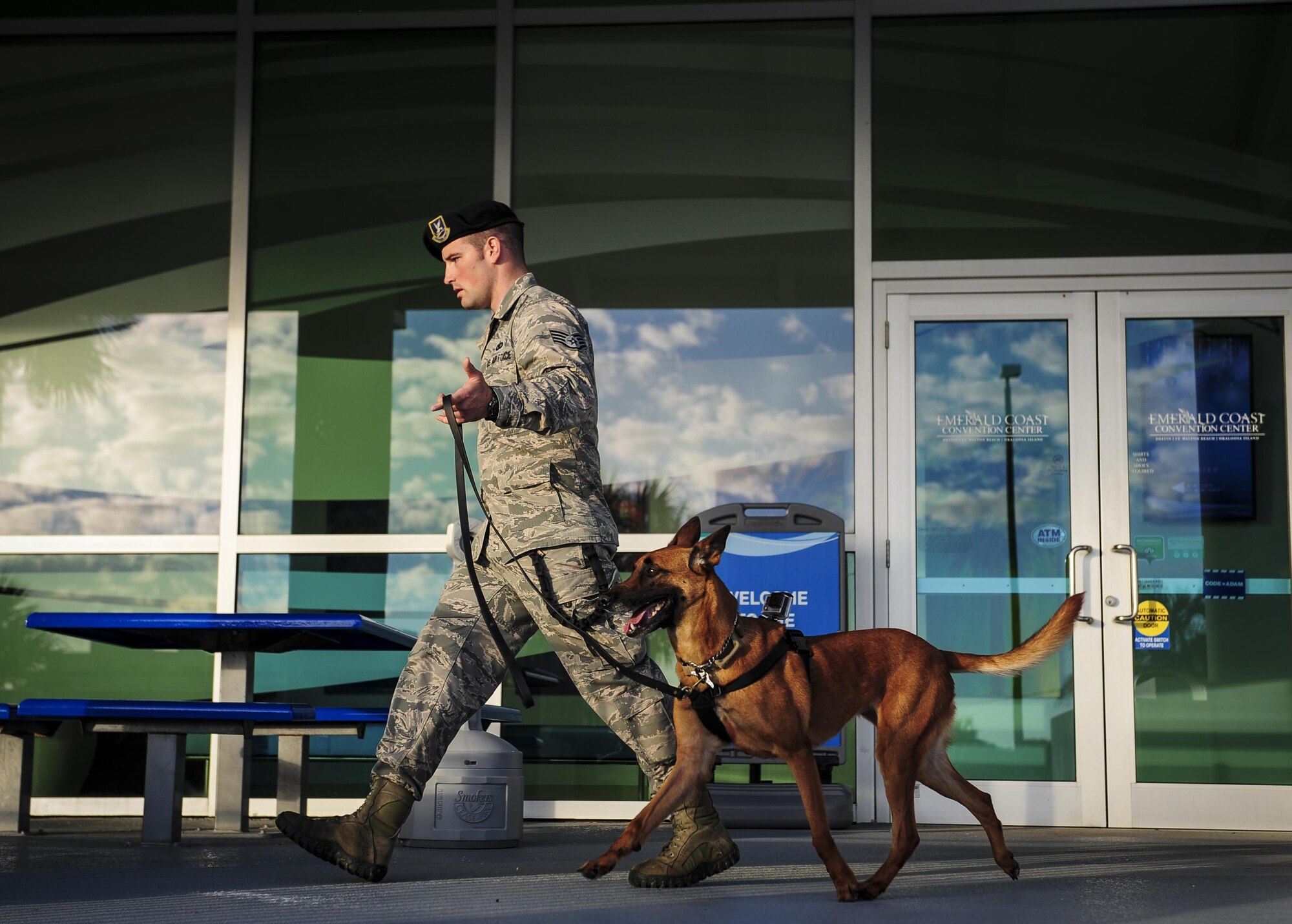 Staff Sgt. Justin Gooding, a military working dog handler with the 1st Special Operations Wing Security Forces Squadron, walks with his military working dog Eella, at the Emerald Coast Convention Center during the Inaugural Gulf Shores Detection Showdown, Dec. 5, 2015. The showdown was hosted Dec. 5-6 by the 1st Special Operations Security Forces Squadron K-9 unit as a friendly competition, and was a learning experience for both handler and K-9, to practice detecting narcotic and explosive odors. (U.S. Air Force photo by Senior Airman Meagan Schutter)