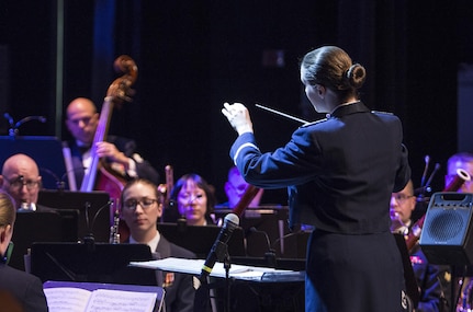 Second Lieutenant Christina A. Muncey, United States Air Force Band of the West flight commander and associate conductor, conducts members of the USAF Band of the West during the Holiday in Blue concert Dec. 7, 2015 at the Edgewood Independent School District Theatre for the Performing Arts in San Antonio, Texas. The concert included a variety of holiday songs from around the world, a children’s story and a sing-a-long. Attendees included members of JBSA, community members and retirees. The Airmen assigned to the band are highly-trained professional musicians who have dedicated themselves to serving their country through music. (U.S. Air Force photo by Johnny Saldivar)