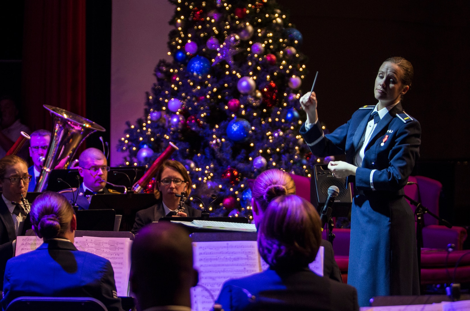 Second Lieutenant Christina A. Muncey, United States Air Force Band of the West flight commander and associate conductor, conducts members of the USAF Band of the West during the Holiday in Blue concert Dec. 7, 2015 at the Edgewood Independent School District Theatre for the Performing Arts in San Antonio, Texas. The concert included a variety of holiday songs from around the world, a children’s story and a sing-a-long. Attendees included members of JBSA, community members and retirees. The Airmen assigned to the band are highly-trained professional musicians who have dedicated themselves to serving their country through music. (U.S. Air Force photo by Johnny Saldivar)