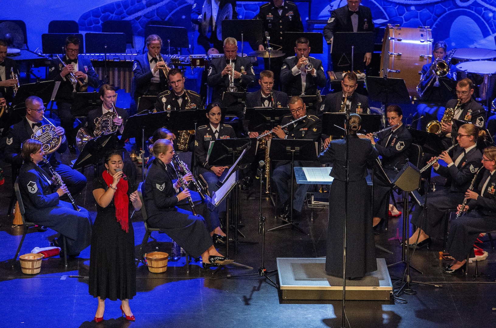 Airman 1st Class Alycia Cancel, United States Air Force Band of the West vocalist, performs during the Holiday in Blue concert Dec. 7, 2015 at the Edgewood Independent School District Theatre for the Performing Arts in San Antonio, Texas. The concert included a variety of holiday songs from around the world, a children’s story and a sing-a-long. Attendees included members of JBSA, community members and retirees. The Airmen assigned to the band are highly-trained professional musicians who have dedicated themselves to serving their country through music. (U.S. Air Force photo by Johnny Saldivar)