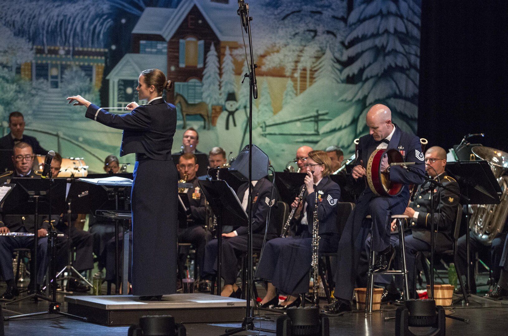 Second Lieutenant Christina A. Muncey, United States Air Force Band of the West flight commander and associate conductor, conducts members of the USAF Band of the West during the Holiday in Blue concert Dec. 7, 2015 at the Edgewood Independent School District Theatre for the Performing Arts in San Antonio, Texas. The concert included a variety of holiday songs from around the world, a children’s story and a sing-a-long. Attendees included members of JBSA, community members and retirees. The Airmen assigned to the band are highly-trained professional musicians who have dedicated themselves to serving their country through music. (U.S. Air Force photo by Johnny Saldivar)