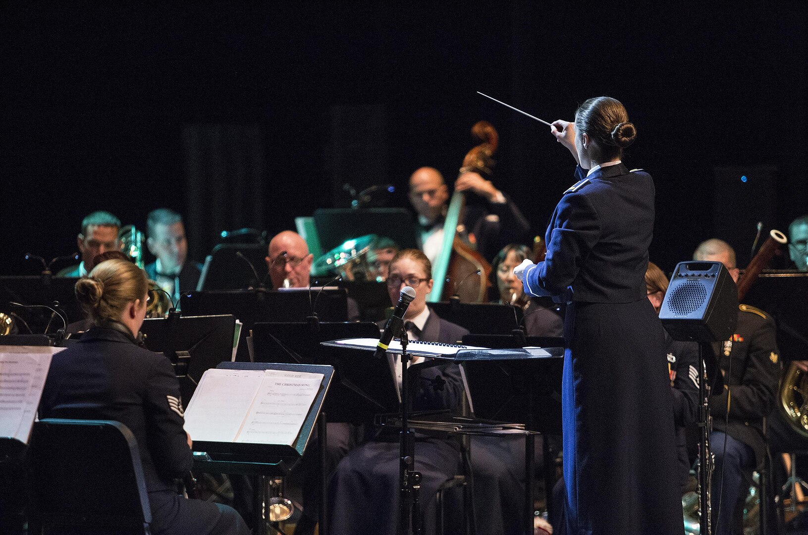 Second Lieutenant Christina A. Muncey, United States Air Force Band of the West flight commander and associate conductor, conducts members of the USAF Band of the West during the Holiday in Blue concert Dec. 7, 2015 at the Edgewood Independent School District Theatre for the Performing Arts in San Antonio, Texas. The concert included a variety of holiday songs from around the world, a children’s story and a sing-a-long. Attendees included members of JBSA, community members and retirees. The Airmen assigned to the band are highly-trained professional musicians who have dedicated themselves to serving their country through music. (U.S. Air Force photo by Johnny Saldivar)