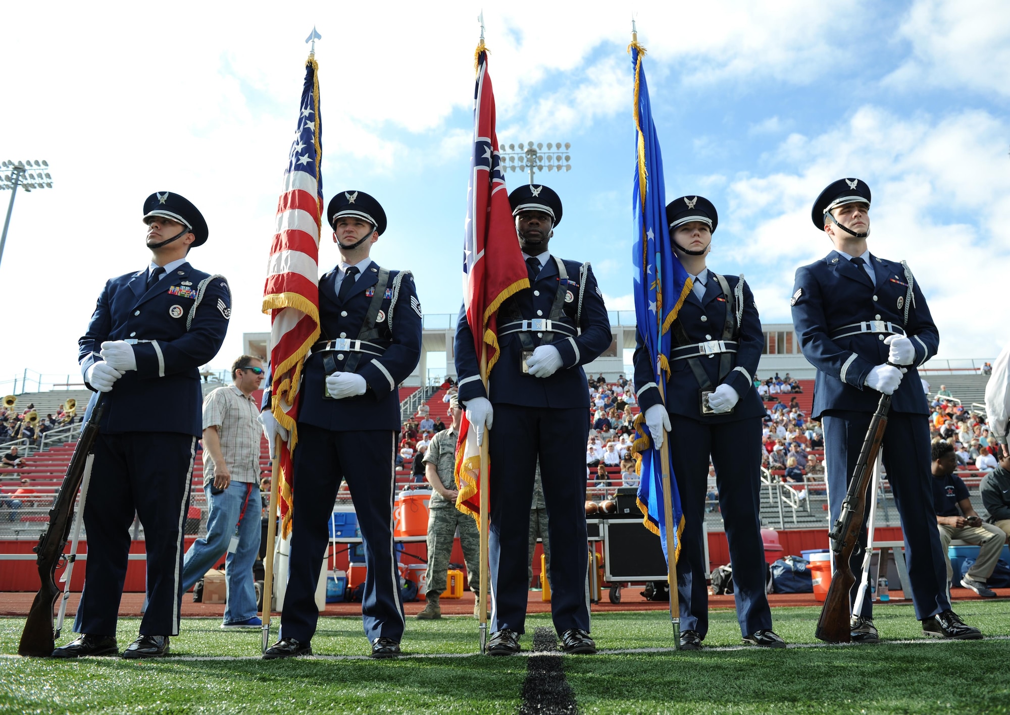 Members of the Keesler Air Force Base Honor Guard prepare to post the colors during the 2015 Mississippi Bowl Dec. 6, 2015, at the Biloxi High School Football Stadium. Col. Dennis Scarborough, 81st Training Wing vice commander, the National Anthem singer and Airmen carrying the 50-State flags also participated in the pre-game celebration. (U.S. Air Force photo by Kemberly Groue)