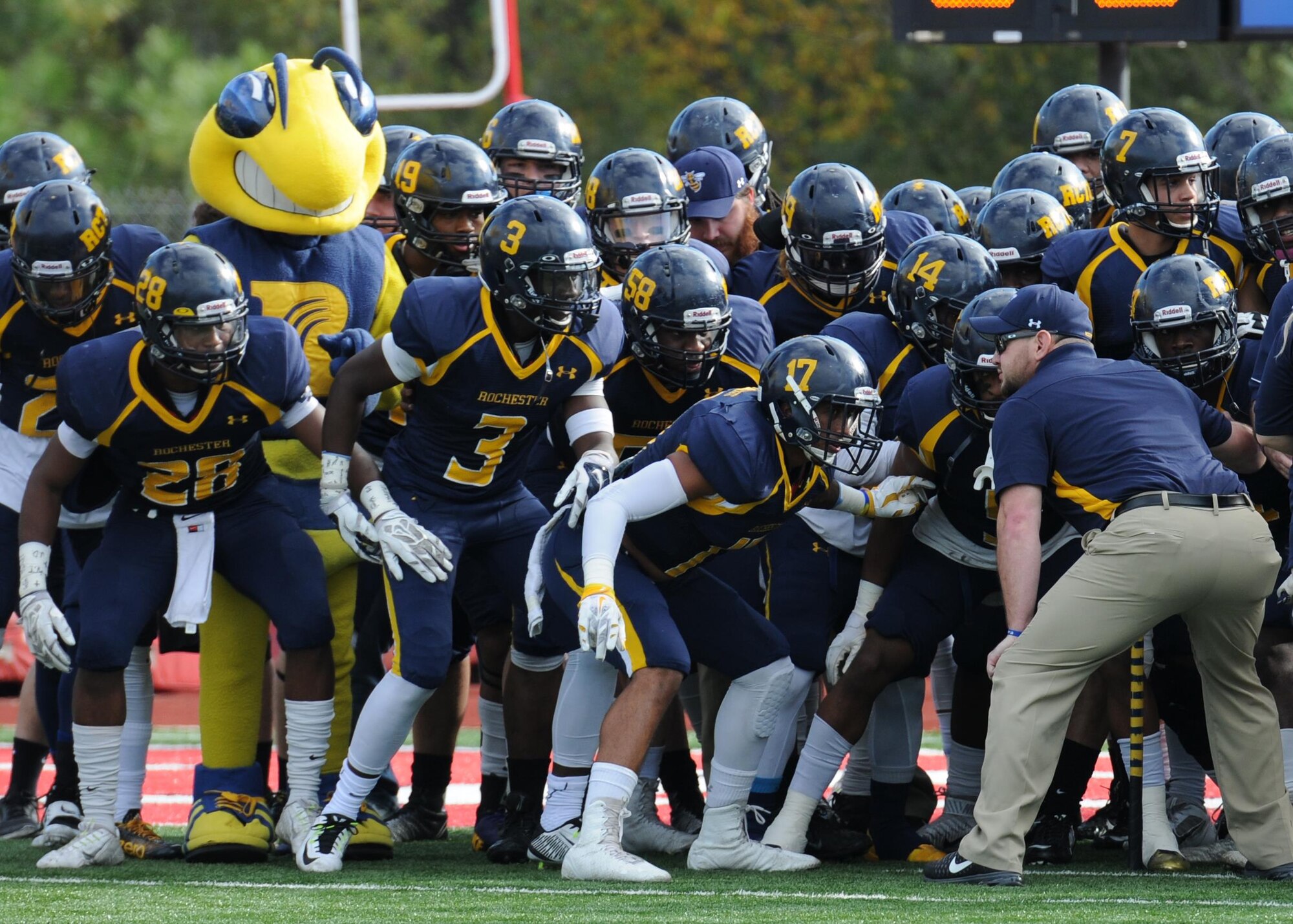 Members of the Rochester Community & Technical College football team prepare to take the field against Northwest Mississippi Community College during the 2015 Mississippi Bowl Dec. 6, 2015, at the Biloxi High School Football Stadium. Col. Dennis Scarborough, 81st Training Wing vice commander, the National Anthem singer and Airmen carrying the 50-State flags also participated in the pre-game celebration. (U.S. Air Force photo by Kemberly Groue)