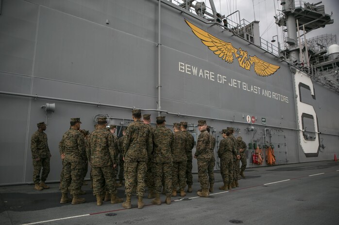 Marines with Marine Aircraft Group 12 and Headquarters and Headquarters Squadron from Marine Corps Air Station Iwakuni, Japan, participate in a site survey and training opportunity aboard the USS Bonhomme Richard at U.S. Fleet Activities Sasebo, Dec. 4, 2015. The site survey was conducted to ensure the area was secure and large enough for Marine Attack Squadron 214 AV-8B harriers to land on safely.