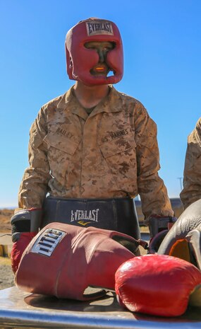 Private Robert J. Bailey, Platoon 3267, Mike Company, 3rd Recruit Training Battalion, waits to fight during body boxing at Edson Range, Weapons and Field Training Battalion, Marine Corps Base Camp Pendleton, Calif., Dec. 2. To ensure their safety, recruits were given protective gear to help shield them from certain strikes from their opponent. Four recruits were assigned to help dress the next recruits in line to fight.