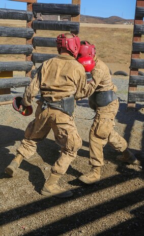 Private Robert J. Bailey, Platoon 3267, Mike Company, 3rd Recruit Training Battalion, spars with another recruit during body boxing at Edson Range, Weapons and Field Training Battalion, Marine Corps Base Camp Pendleton, Calif., Dec. 2. Recruits were instructed to refrain from delivering headshots to prevent disabling their opponent. After graduating from the School of Infantry, Bailey will go to school to eventually become a motor transportation operator.