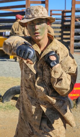 Private Robert J. Bailey, Platoon 3267, Mike Company, 3rd Recruit Training Battalion, executes rear-hand punches after body boxing at Edson Range, Weapons and Field Training Battalion, Marine Corps Base Camp Pendleton, Calif., Dec. 2. To keep the rest of the recruits busy while waiting for their turn to fight, the recruits participate in Marine Corps Martial Arts Program exercises led by their squad leaders. After graduating from recruit training, Bailey will attend the School of Infantry to further his training.