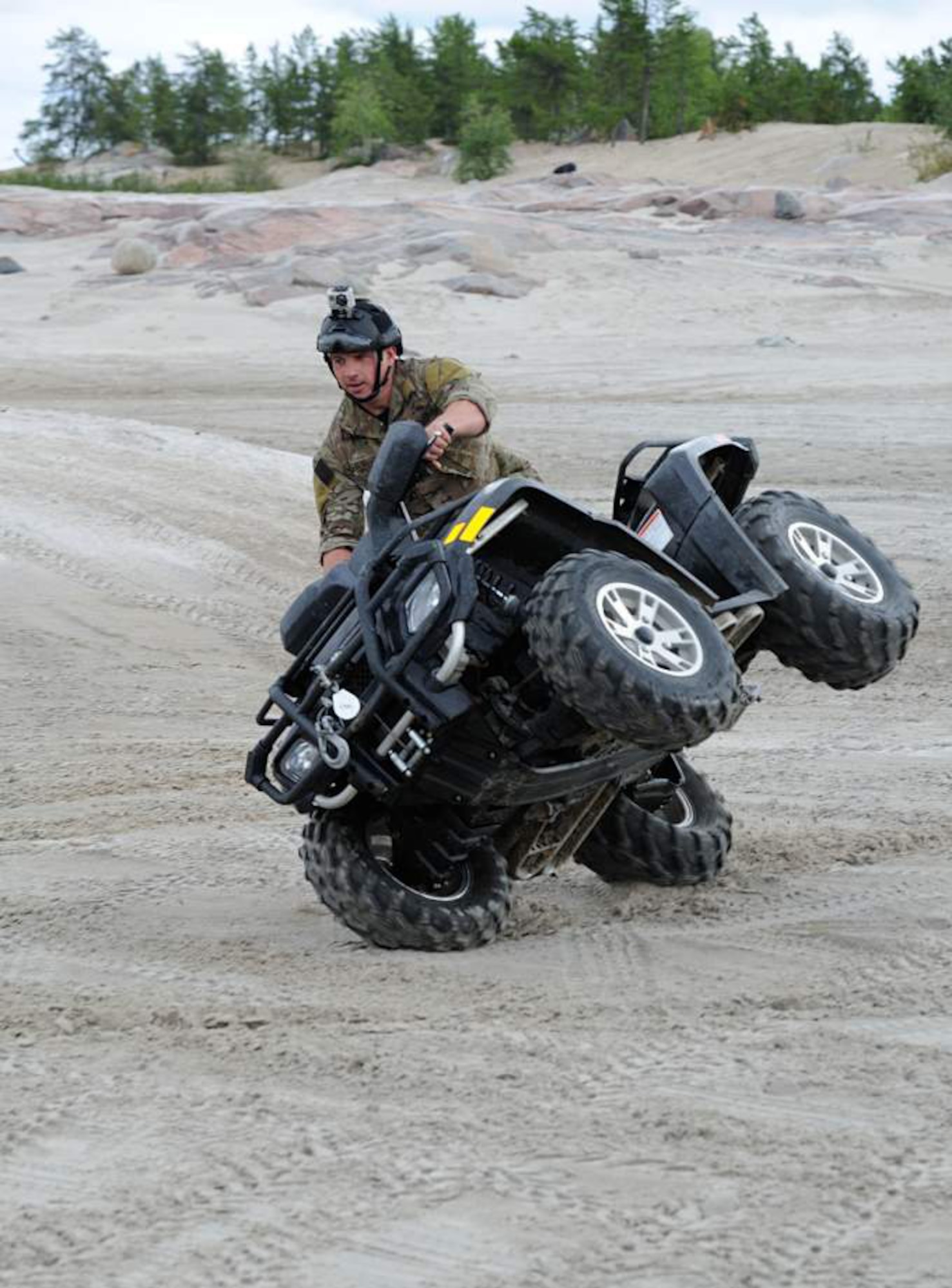 Capt. Jim Sluder, a combat rescue officer with the 308th Rescue Squadron, rides an all-terrain vehicle as in Yellowknife, Canada, as part of a search-and-rescue exercise with Canadian search-and-rescue technicians. Members of the 308th RQS, part of the 920th Rescue Wing at Patrick Air Force Base, Fla., train with Canadian SAR Techs three times per year.