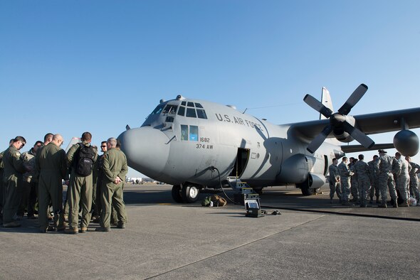 Members of the 374th Airlift Wing review safety procedures before leaving for Andersen Air Force Base, Guam, in support of Operation Christmas Drop 2015, at Yokota Air Base, Japan, Dec. 7, 2015. This year’s OCD will be the first to include trilateral training with air support from the Japan Air Self-Defense Force and Royal Australian Air Force. (U.S. Air Force photo by Senior Airman David C. Danford/Released)