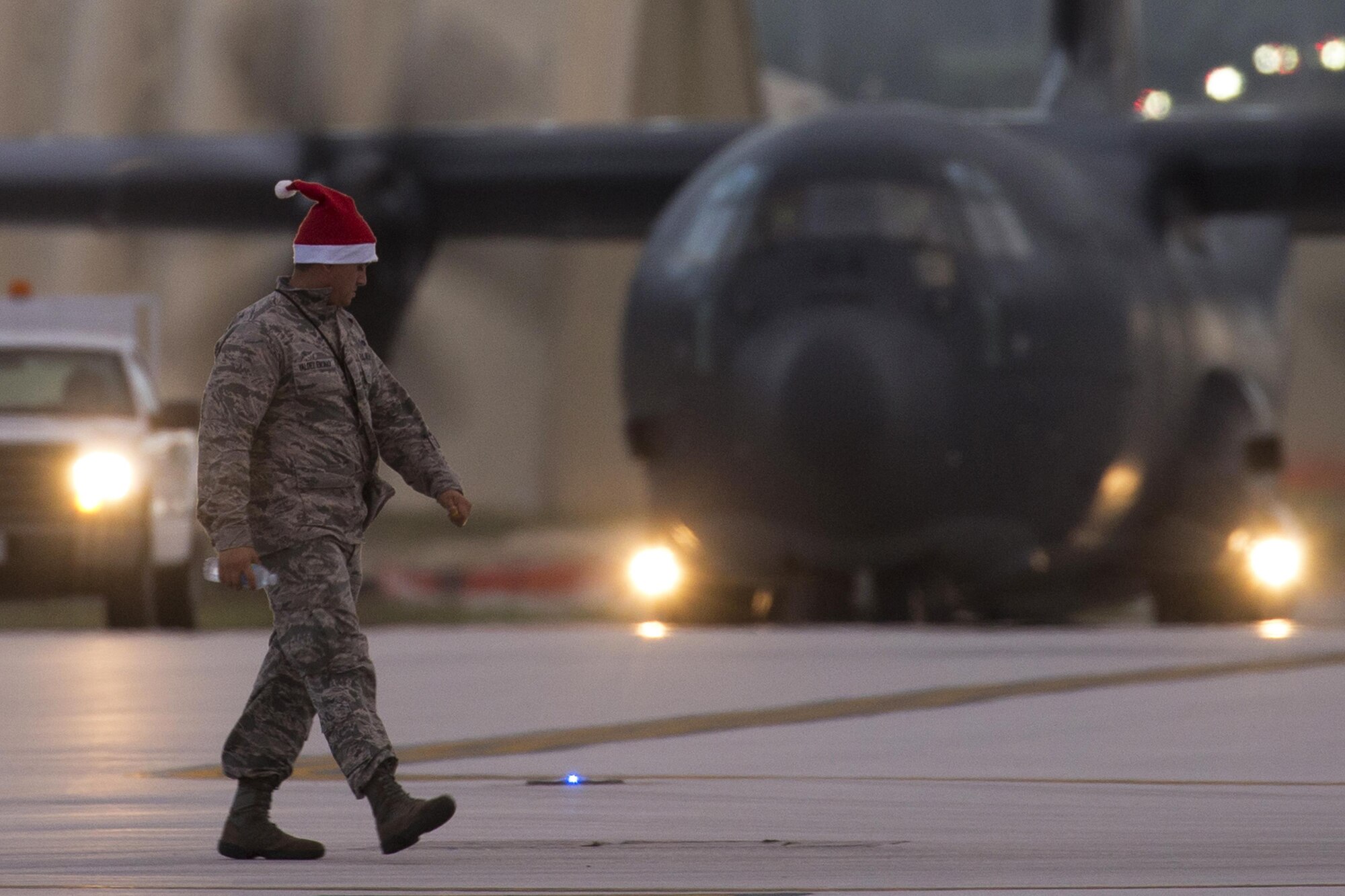 First Lt. Ben Valdes Encinas, 374th Aircraft Maintenance Squadron officer in charge, walks across the flightline before greeting his Australian counterparts at Andersen Air Force Base, Guam, Dec. 4, 2015. Operation Christmas Drop 2015 is the first ever trilateral training event that includes additional air support from the Japan Air Self-Defense Force and Royal Australian Air Force C-130 aircrews. (U.S. Air Force photo by Osakabe Yasuo/Released)