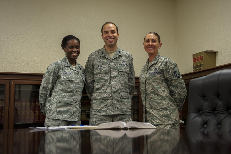 U.S. Air Force Capt. Yolanda Miller (left), Capt. Joseph Wise (center), area defense counselors, and Master Sgt. Stephanie Clark (right), Area Defense Counsel paralegal, make up the ADC team. The ADC is comprised of two attorneys and a paralegal who provide legal counsel to Airmen. (U.S. Air Force photo by Airman 1st Class Corey M. Pettis)