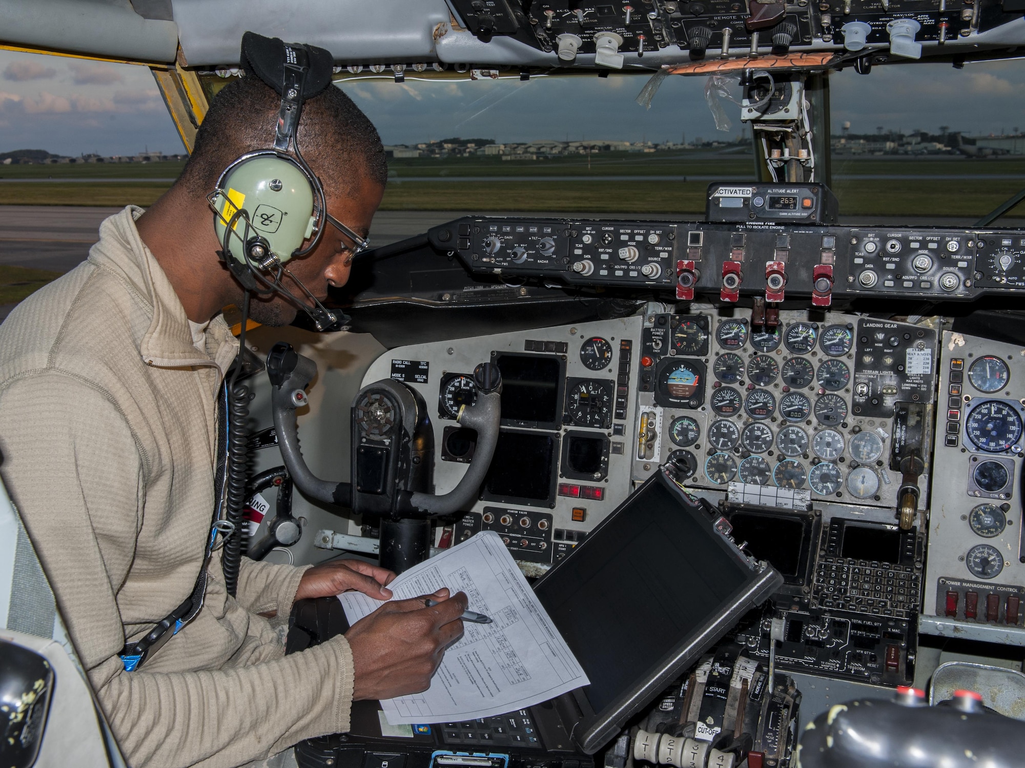 U.S. Air Force Senior Airman Jonathan Hicks, 909th Aircraft Maintenance Unit communications and navigations journeyman, works through his technical orders to prepare a KC-135 Stratotanker for refueling Dec. 7, 2015, on Kadena Air Base, Japan. The technical orders ensure a safe and correctly executed job. (U.S. Air Force photo by Airman Zackary A. Henry)