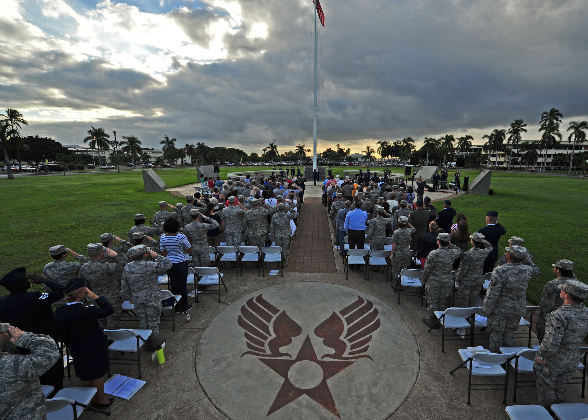 Military members salute during the singing of the National Anthem during the 74th attack on Hickam Field Remembrance Ceremony hosted by the 15th Wing on Joint Base Pearl Harbor-Hickam, Hawaii, Dec. 7, 2015. Survivors and their family members attended the ceremony, which honors the men and women who lost their lives on Hickam Field during the two waves of attacks launched by the Imperial Japanese Navy on Dec. 7, 1941. (U.S. Air Force photo by Tech. Sgt. Aaron Oelrich/Released) 