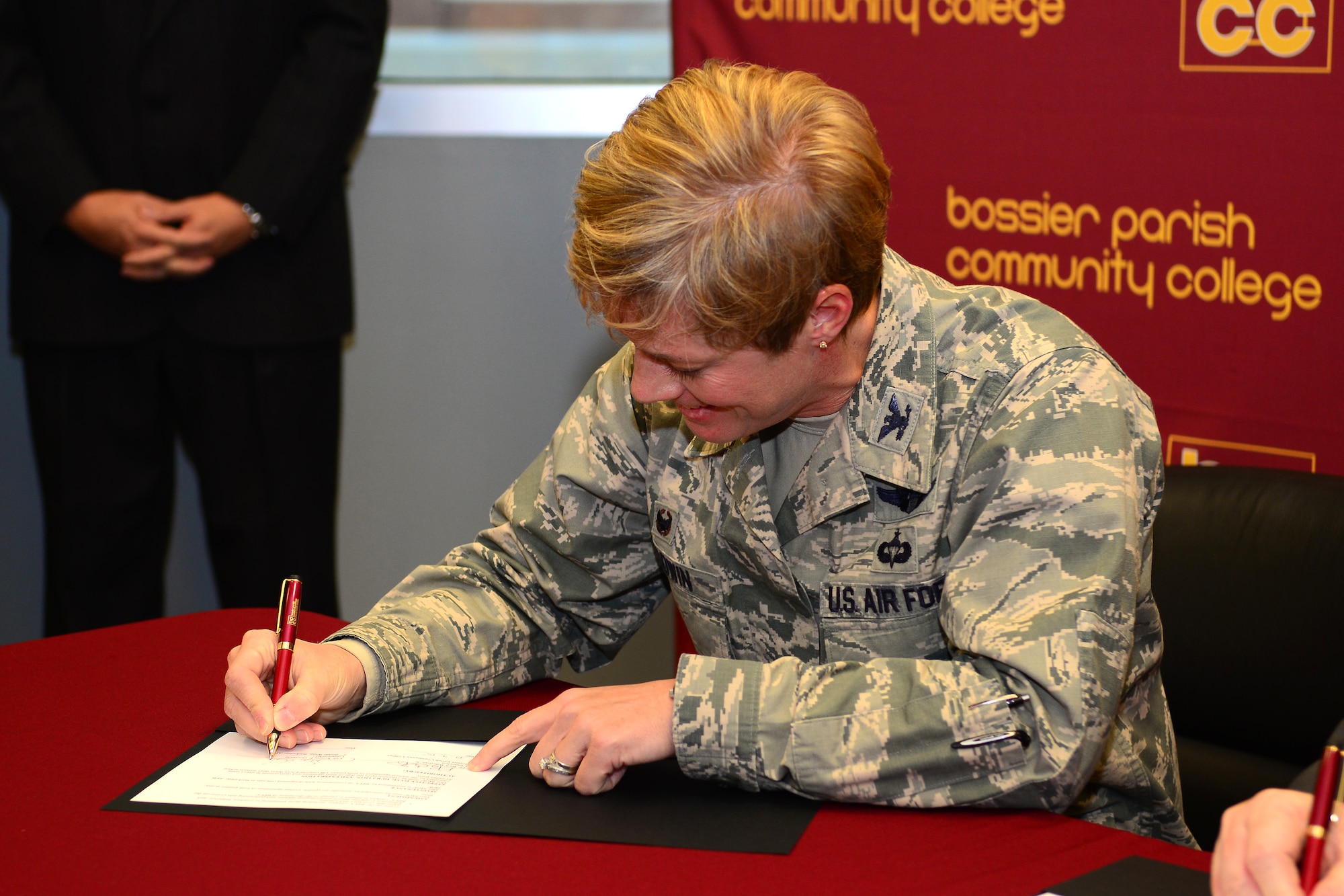 Col. Kristin Goodwin, 2nd Bomb Wing commander, and Rick Bateman Jr., Bossier Parish Community College chancellor, sign a proclamation giving Airmen and their families a chance to attend sports and performing arts events free of charge at BPCC, Dec. 4, 2015. During the signing, Goodwin spoke to BPCC students about the 2nd Bomb Wing's priorities of people, mission and pride, and how they align with BPCC's goal of empowering students and Airmen.
