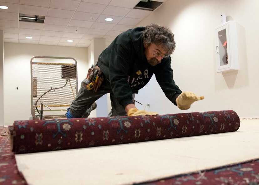 Bill O’brien, Kaiser Flooring contractor, rolls up old carpet in the Trail’s End Event Center on F.E. Warren Air Force Base, Wyo., Dec. 7, 2015. All of the carpets within the facility are slated to be removed and replaced with brand new and more modern carpet. (U.S. Air Force photo by Airman 1st Class Malcolm Mayfield)