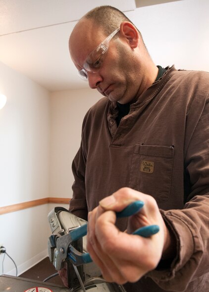 Chris Durben, Simpsons Electric contractor, modifies a clamp for the fire alarm system in the Trail’s End Event Center on F.E. Warren Air Force Base, Wyo., Dec. 7, 2015. Contractors officially began construction in late September 2015 and were given 280 days to complete the renovation. (U.S. Air Force photo by Airman 1st Class Malcolm Mayfield)