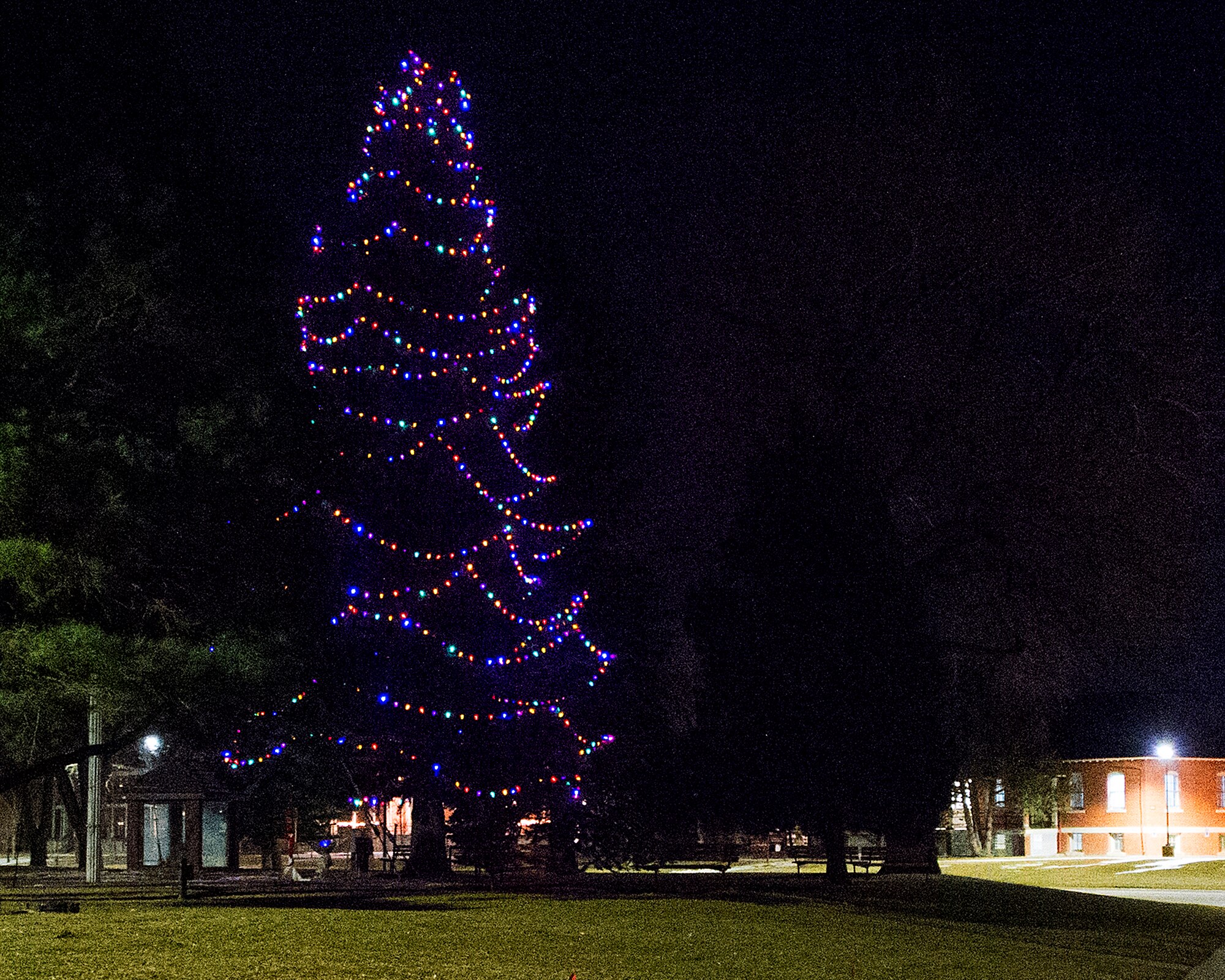 The F.E. Warren Air Force Base, Wyo., holiday tree glows with multicolored lights Dec. 4, 2015, following the annual tree lighting festivities. (U.S. Air Force photo by R.J. Oriez) 