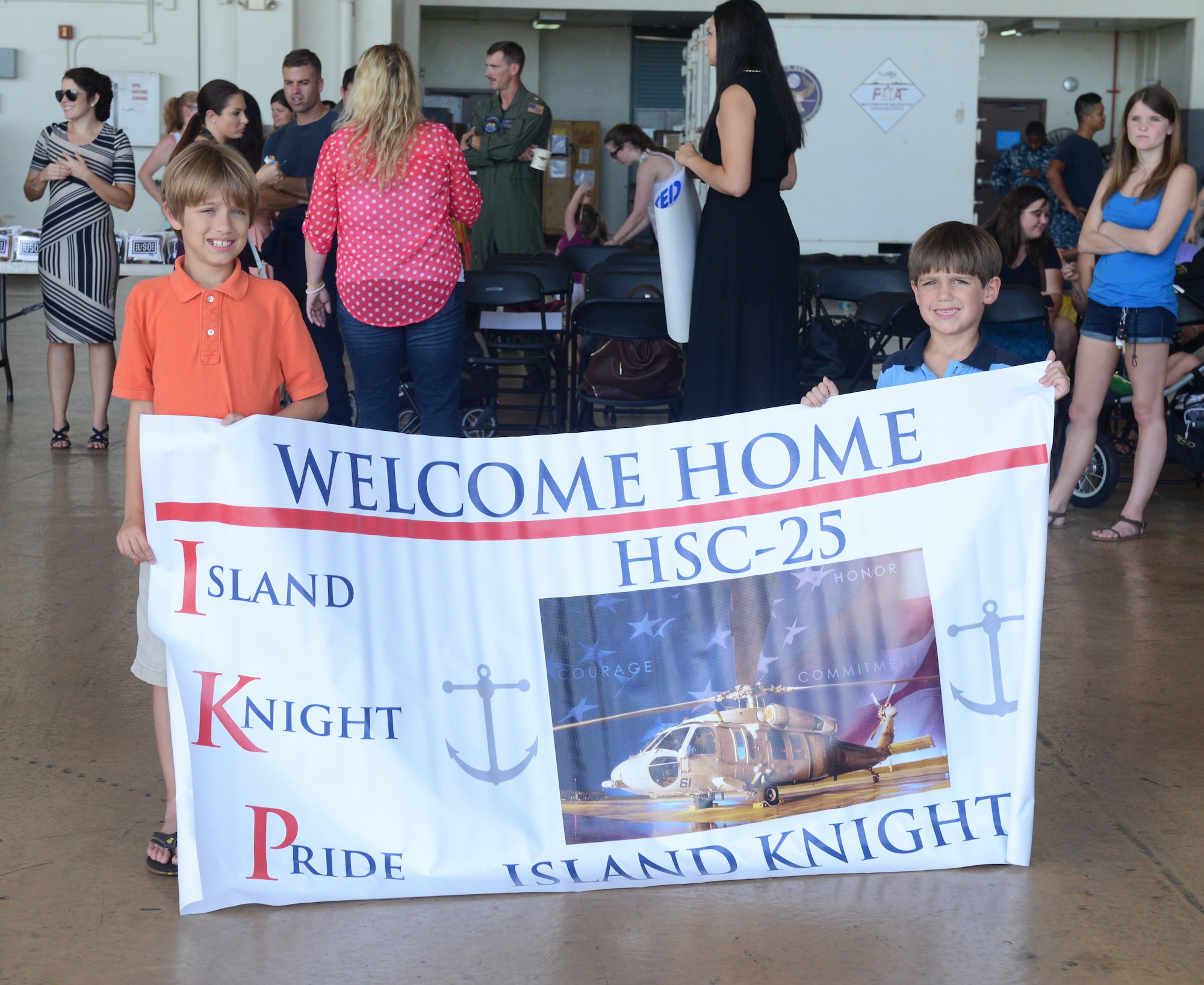 Families, friends and loved ones welcome home U.S. Navy Detachment 6 Sailors after a seven month deployment Dec. 7, 2015, at Andersen Air Force Base, Guam. The Sailors supported a Combat Logistics Force mission from the USNS Washington Chambers in support of Commander Task Force 73. (U.S. Air Force photo by Airman 1st Class Arielle Vasquez/Released)