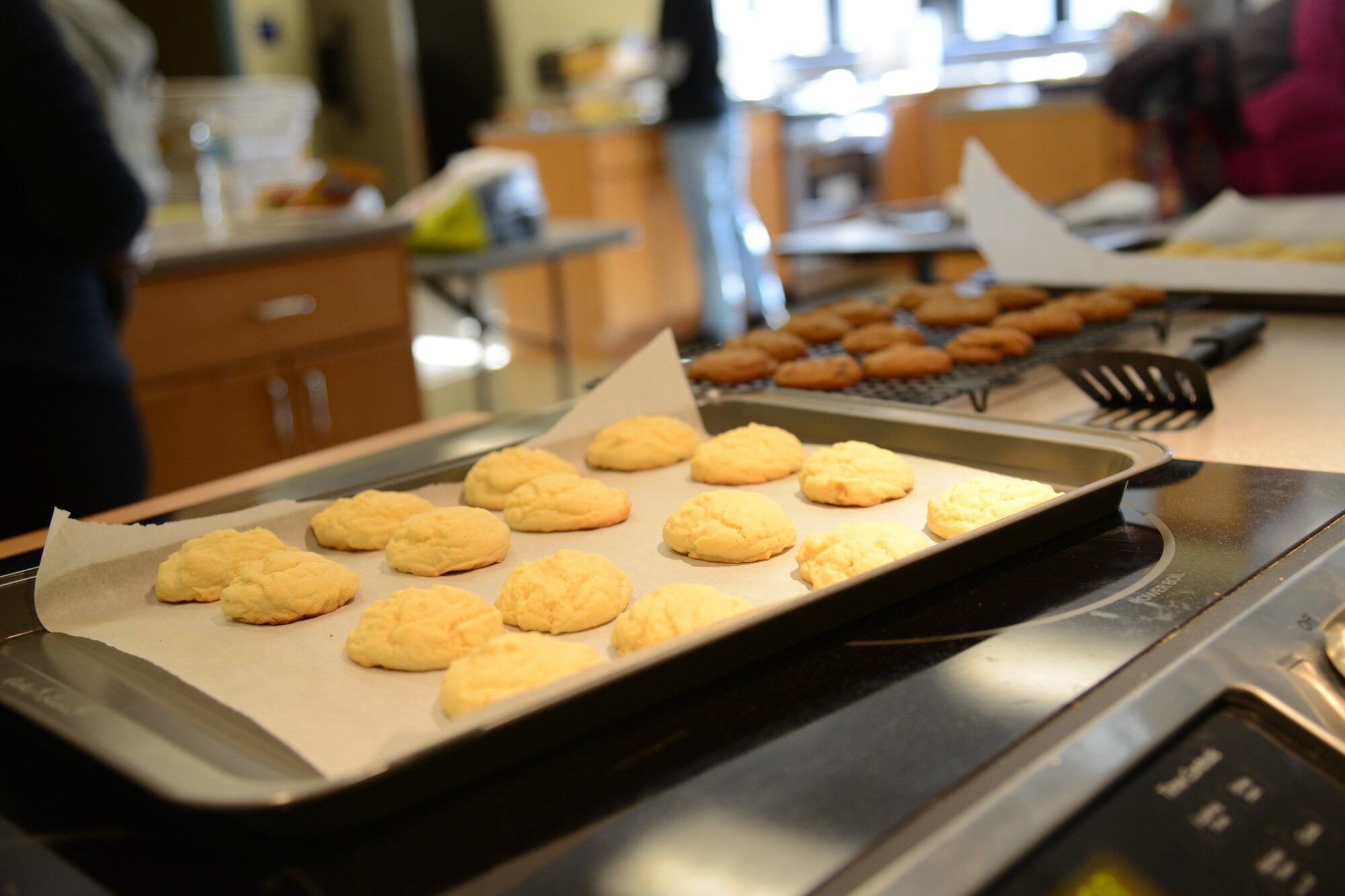 Pans of cookies cool after baking during Operation Sweet Treat at Osan Air Base, Republic of Korea, Dec. 5, 2015. Team Osan volunteers baked more than 108,000 cookies to deliver to the base’s unaccompanied Airmen. (U.S. Air Force photo/Airman 1st Class Dillian Bamman)