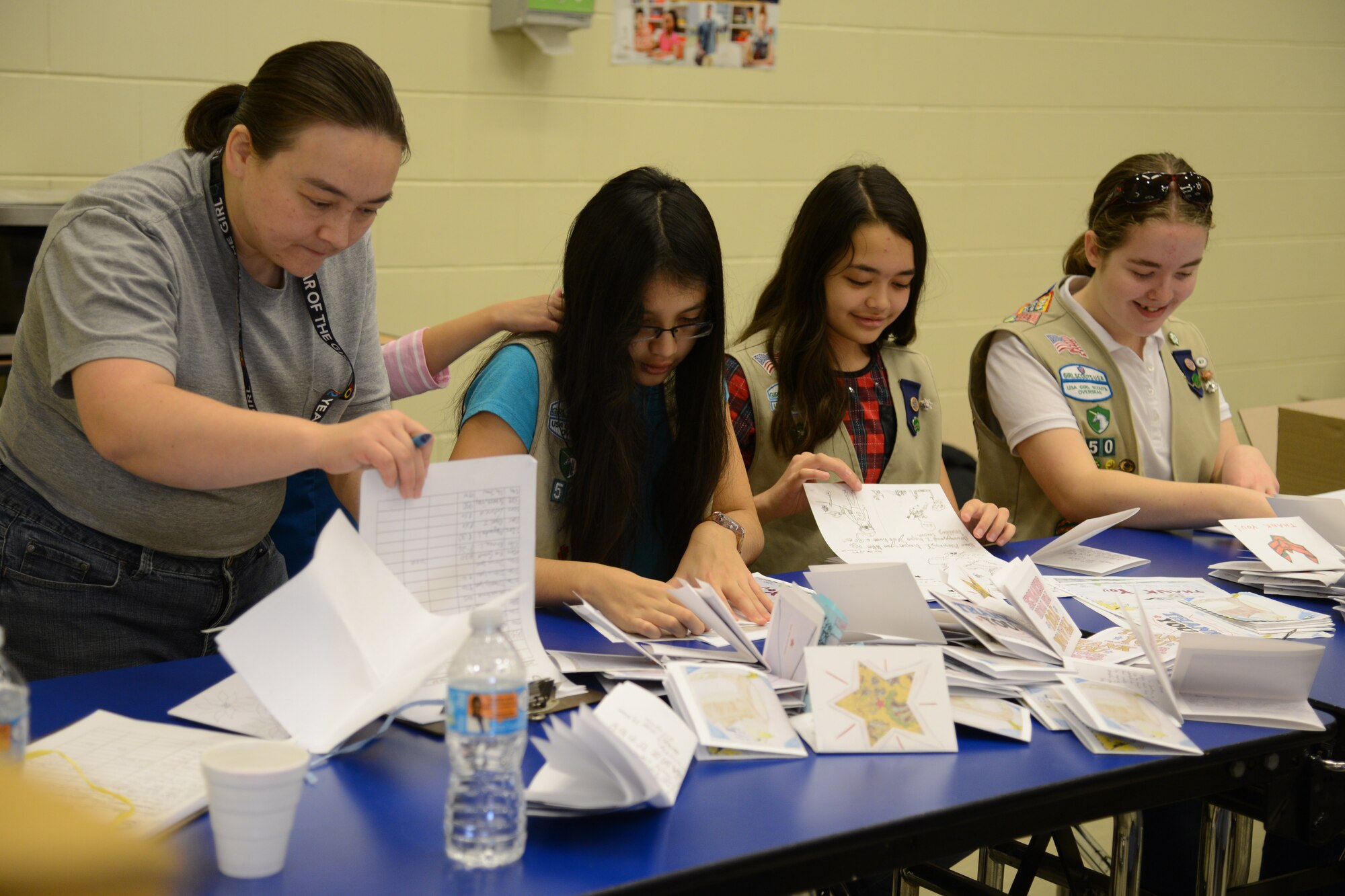 Volunteers with the Girl Scouts of America prepare Christmas cards for Operation Sweet Treat at Osan Air Base, Republic of Korea, Dec. 5, 2015. The volunteers decorated the cards to give with bags of cookies to unaccompanied Airmen living in dormitories. (U.S. Air Force photo/Airman 1st Class Dillian Bamman)