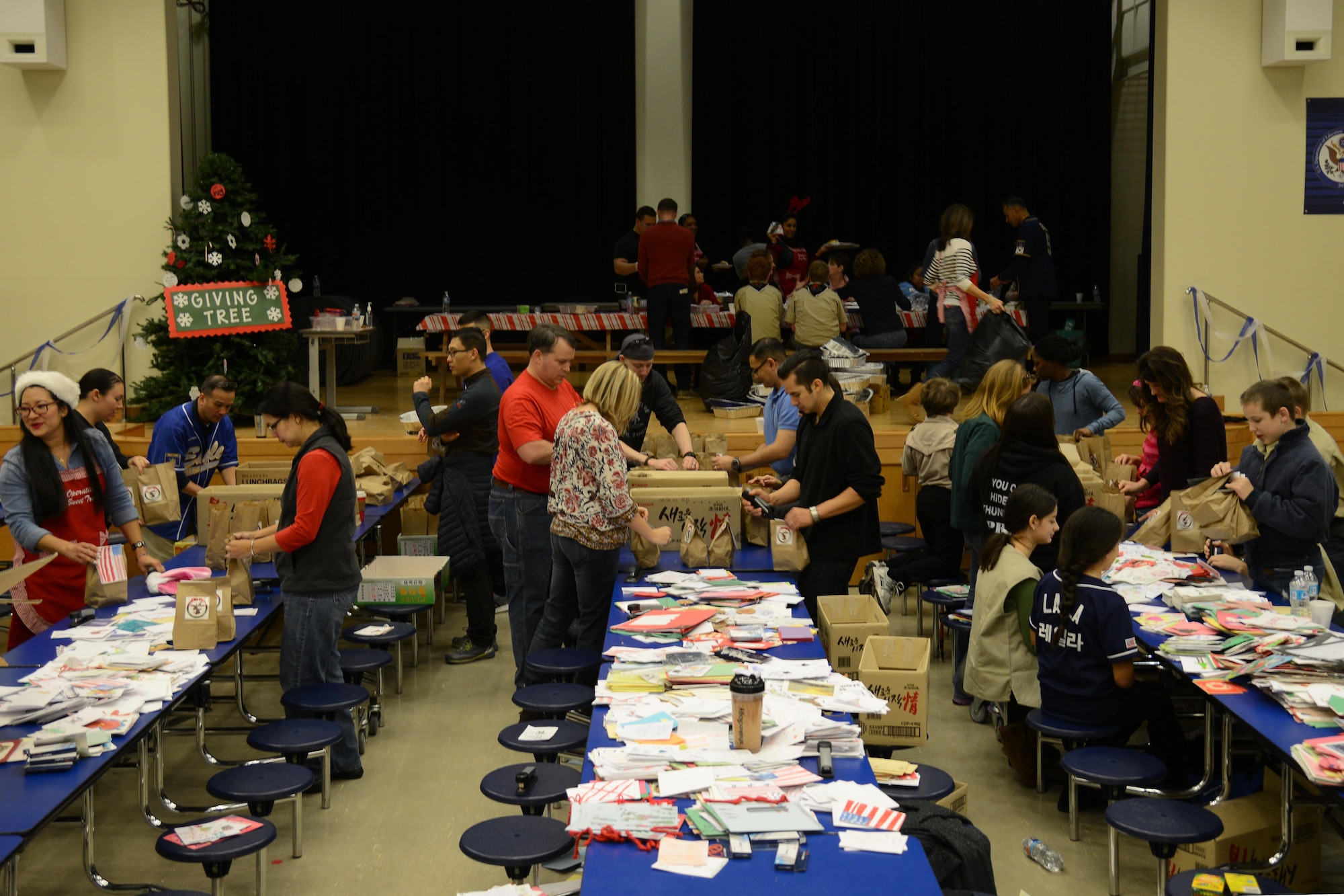 Volunteers of Team Osan prepare bags of cookies for unaccompanied Airmen during Operation Sweet Treat at Osan Air Base, Republic of Korea, Dec. 5, 2015. The Osan Spouses Club organized the event to build morale for Airmen away from their families for the holidays. (U.S. Air Force photo/Airman 1st Class Dillian Bamman)