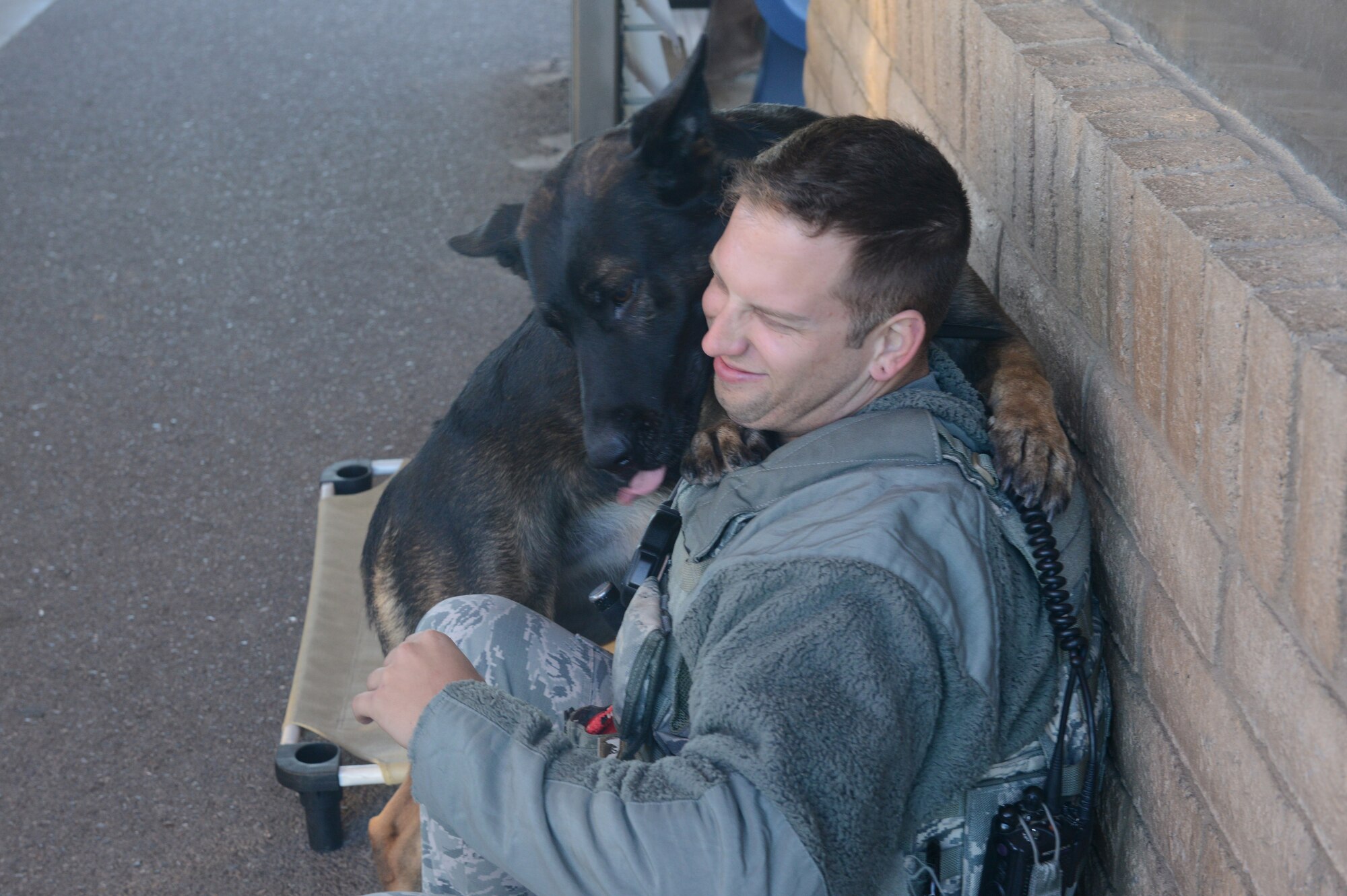 Rango, 56th Security Forces Squadron military working dog, licks Staff Sgt. Justin Gonzalez, 56th Security Forces Squadron MWD handler, at Luke Air Force Base, Arizona, Nov. 17, 2015. It’s important for MWD handlers to develop a good working relationship with their dogs to strengthen the bond between them, Gonzalez said. (U.S. Air Force photo by Senior Airman James Hensley)