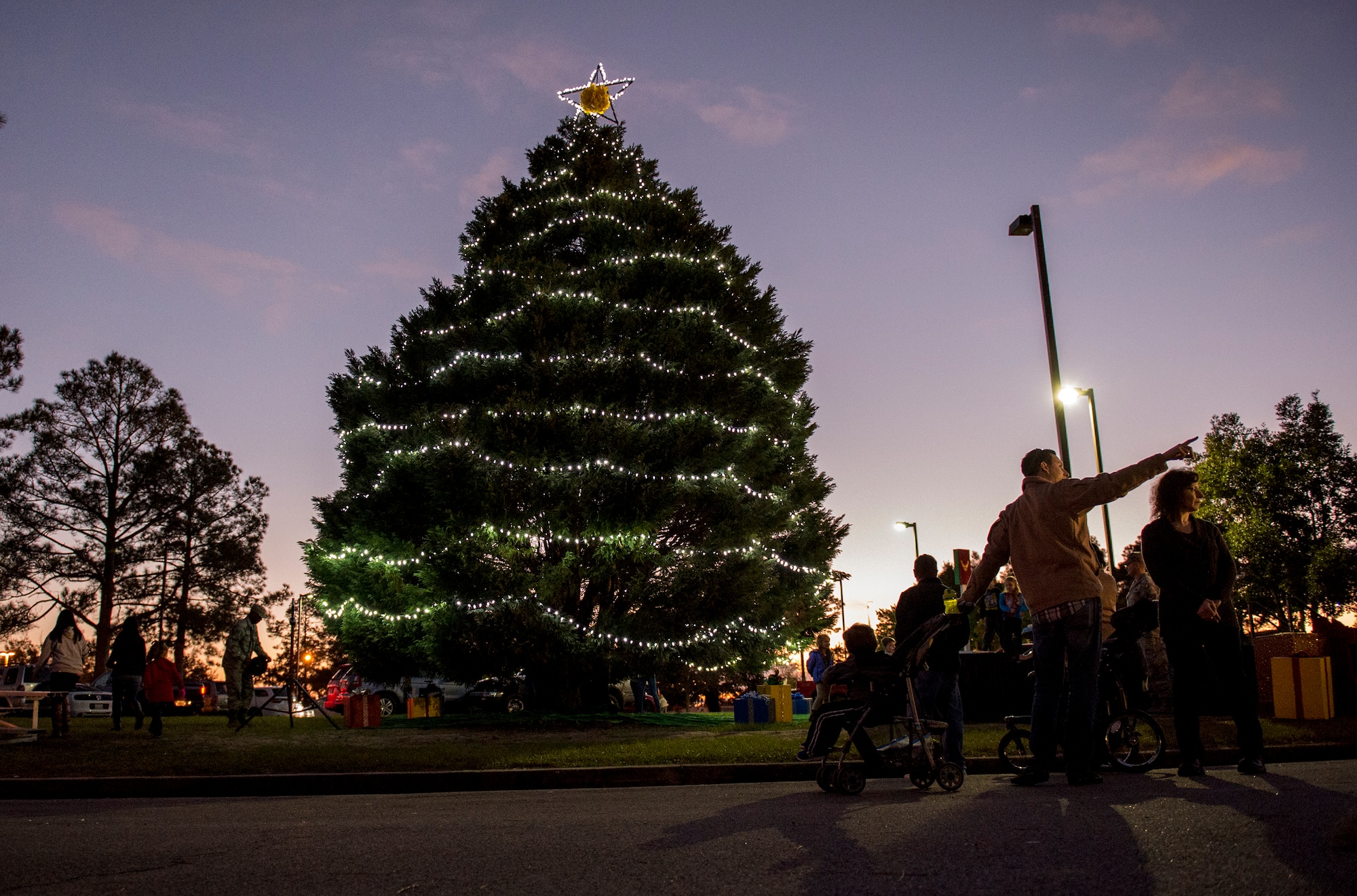 Attendees of the tree-lighting ceremony look at the tree that was lit, Dec. 4, 2015, at Moody Air Force Base, Ga. Children met Mr. and Mrs. Claus and played in over 100,000 pounds of snow that was made before the ceremony began. (U.S. Air Force photo/Tech. Sgt. Zachary Wolf)