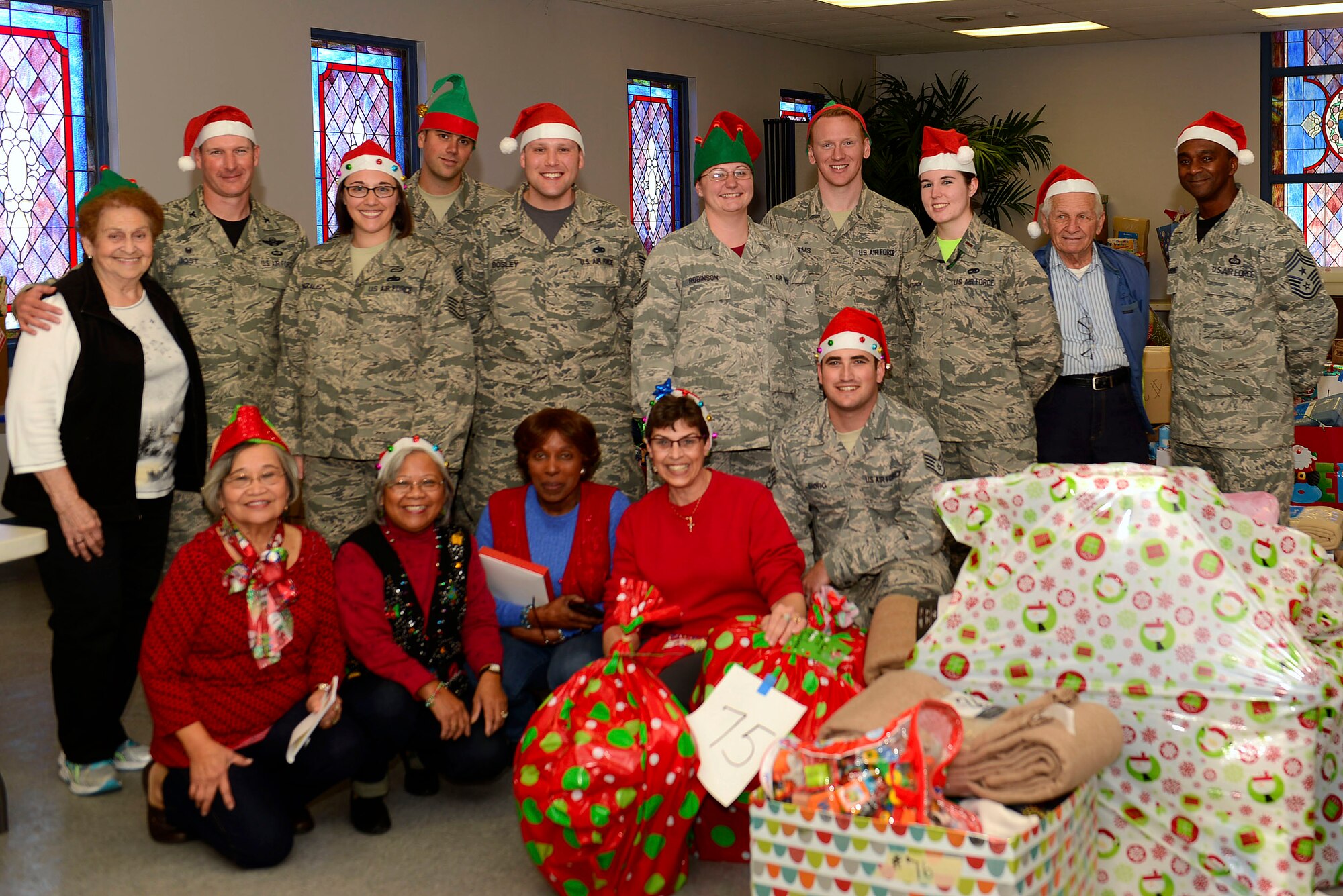 Shaw Leadership and volunteers for Operation True Giving, pose for a group photo at the Palmetto Chapel at Shaw Air Force Base, S.C., Dec. 4, 2015. For the last 31 years Operation True Giving, a non-profit organization, has assisted less fortunate families in the Shaw and Sumter community. (U.S. Air Force photo by Airman 1st Class Christopher Maldonado)