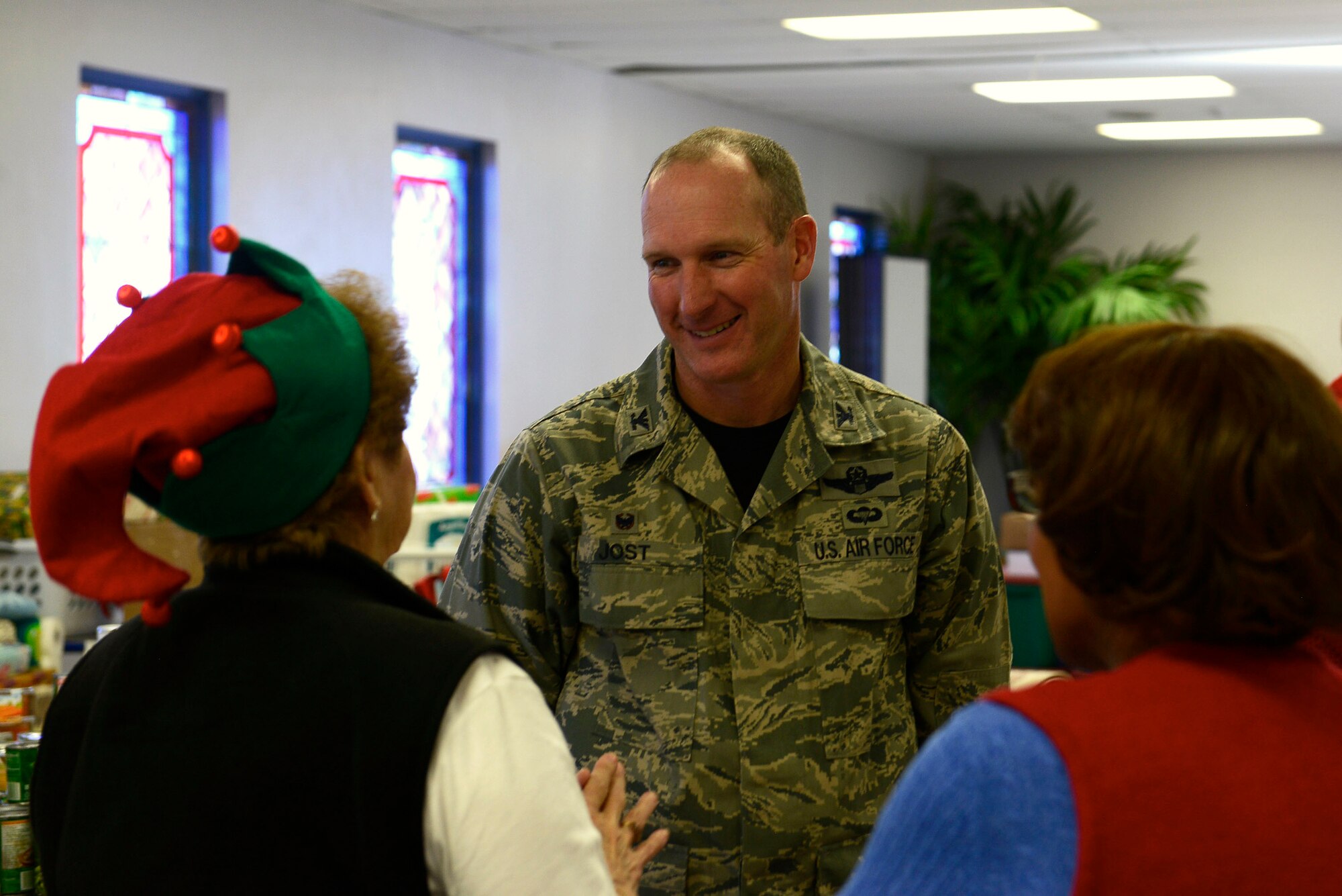 U.S. Air Force Col. Stephen Jost, 20th Fighter Wing commnader, talks with volunteers at the Palmetto Chapel at Shaw Air Force Base, S.C., Dec. 4, 2015. Jost made a visit to the Palmetto Chapel to show his support for Operation True Giving and what it provides for the Shaw and Sumter community. (U.S. Air Force photo by Airman 1st Class Christopher Maldonado)