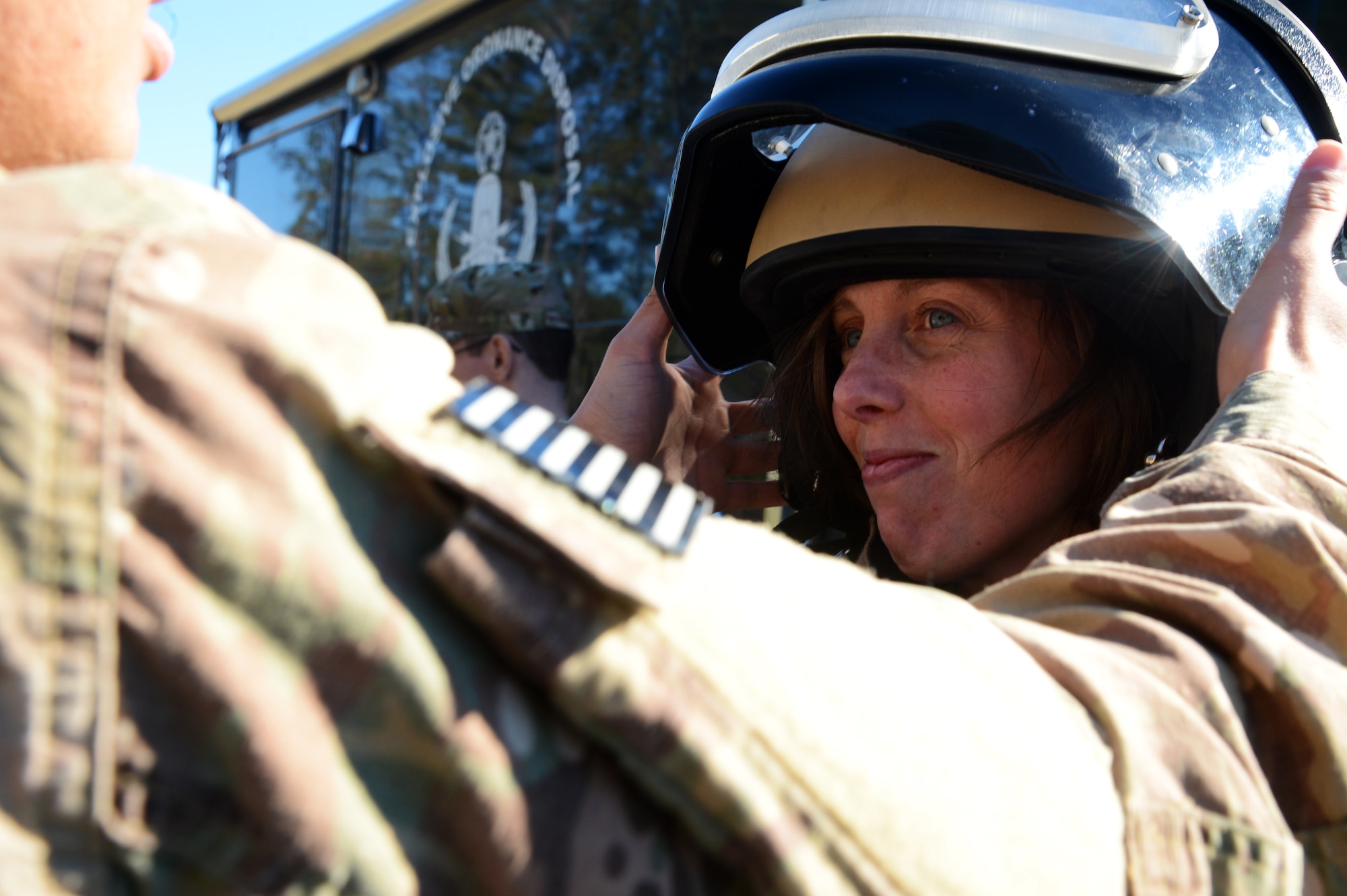 U.S. Air Force Staff Sgt. Jennifer Poore, 20th Comptroller Squadron non-commissioned officer in charge of customer service, smiles as she tries on a bomb suit during the 20th Civil Engineer Squadron Explosive Ordnance Disposal flight’s working demonstration at Shaw Air Force Base, S.C., Dec. 4, 2015. During the demonstration, Airmen from the 20th Fighter Wing Staff Agencies and 20th Comptroller Squadron had the opportunity to learn how EOD accomplishes their mission. (U.S. Air Force photo by Senior Airman Jonathan Bass)