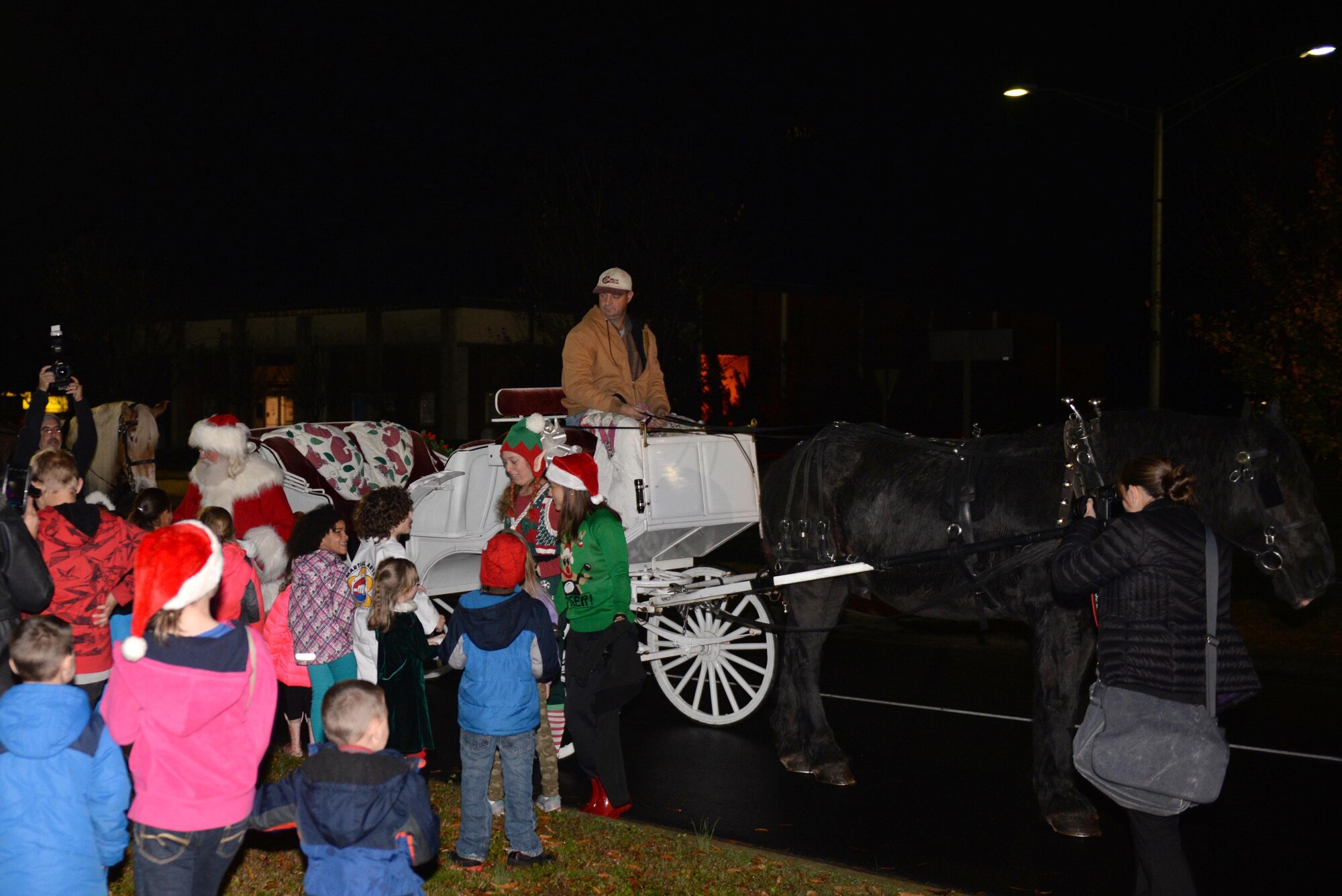 Santa arrives during the base tree lighting ceremony, Dec. 7, 2015, at Seymour Johnson Air Force Base, North Carolina.  Santa took photos with children and listened to their Christmas wishes. (U.S. Air Force photo/Airman 1st Class Ashley Williamson)