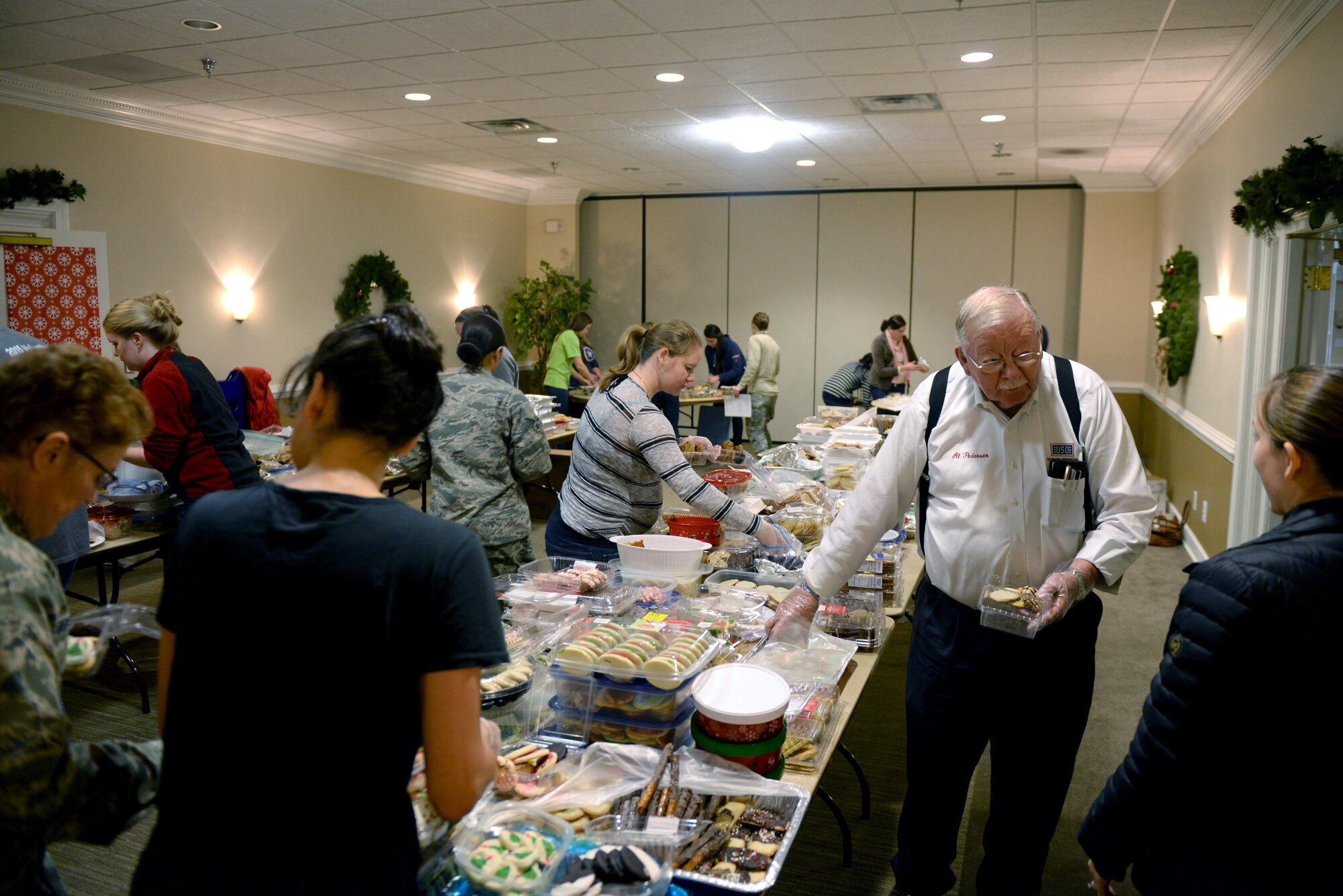 Local community members prepare boxes of cookies and holiday cards for Airmen residing in the base dorms, Dec. 7, 2015, at Seymour Johnson Air Force Base, North Carolina. After distributing to dorm members, any leftover boxes of cookies will be sent to deployed Airmen during the holidays. (U.S. Air Force photo/Airman 1st Class Ashley Williamson)