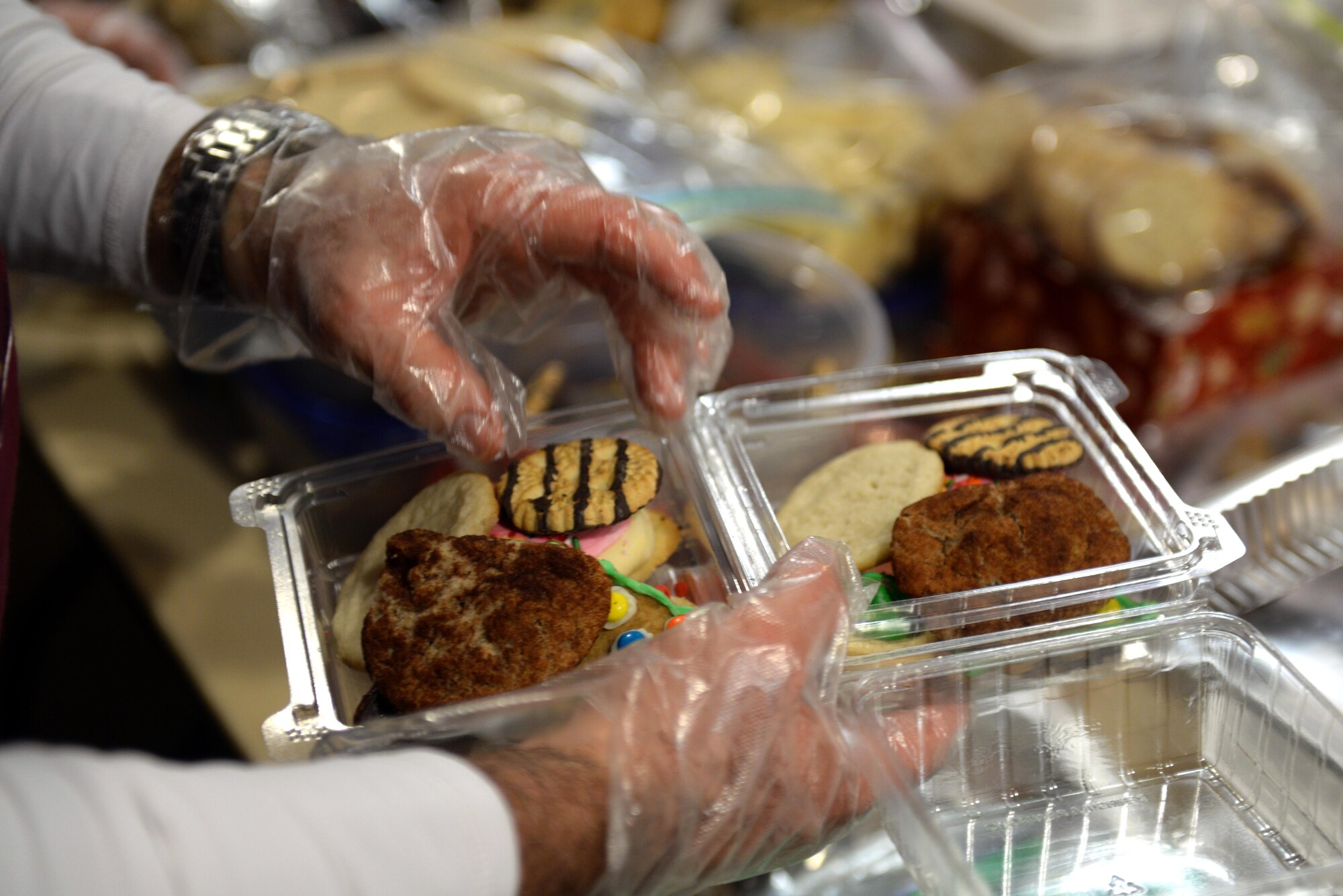 Members of Team Seymour fill boxes with holiday cookies, Dec. 7, 2015, at Seymour Johnson Air Force Base, North Carolina. Service members, spouses, churches and community groups donated cookies to send as treats to Airmen unable to visit their families for the holidays. (U.S. Air Force photo/Airman 1st Class Ashley Williamson)
