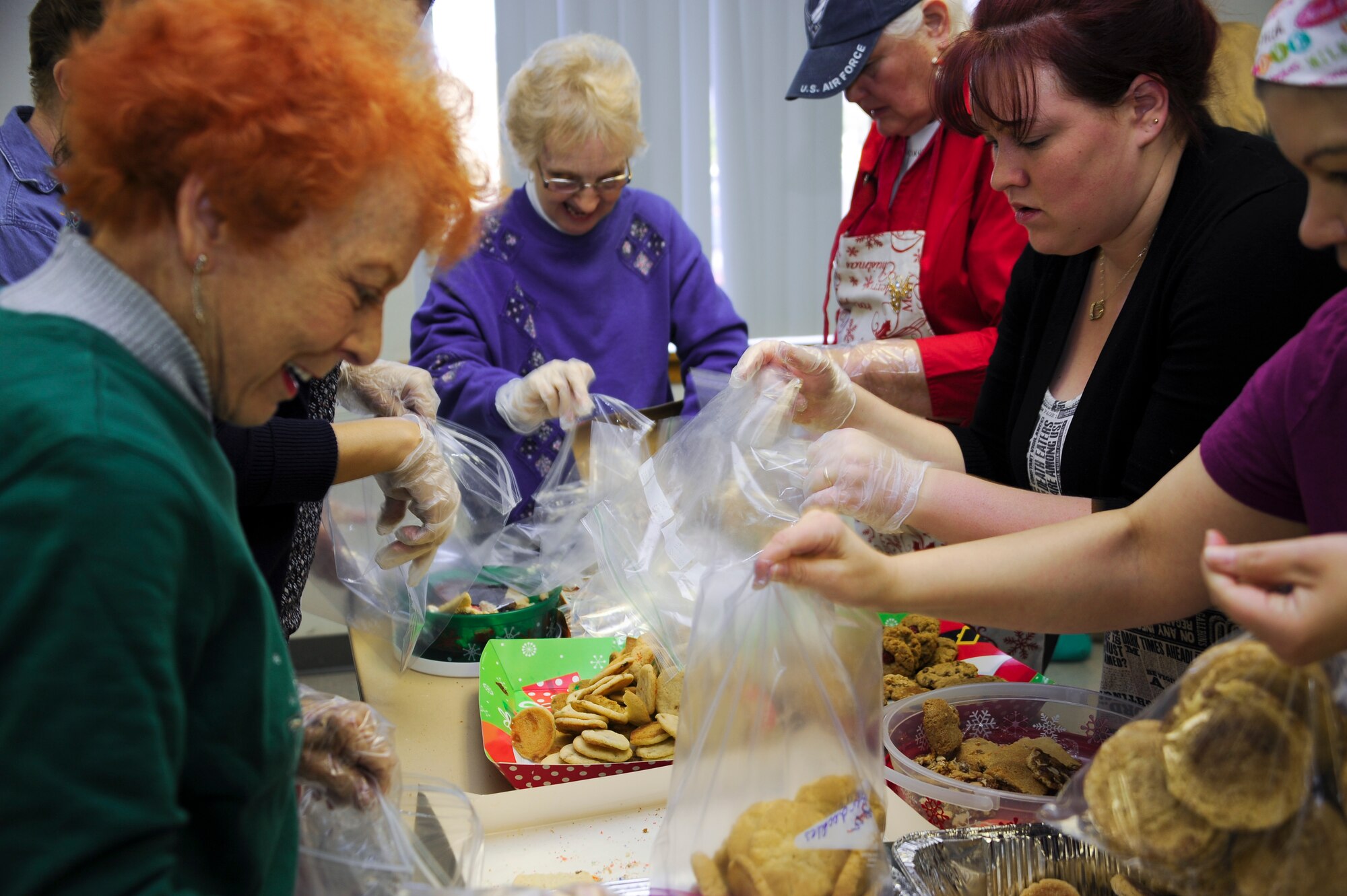 Volunteers bag a variety of cookies at the annual Cookie Crunch at Davis-Monthan Air Force Base, Ariz., Dec. 7, 2015. The Cookie Crunch was organized by the Officers’ Spouses’ Club and cookies are collected and distributed to Airmen living in the dorms. (U.S. Air Force photo by Airman 1st Class Ashley N. Steffen/Released)