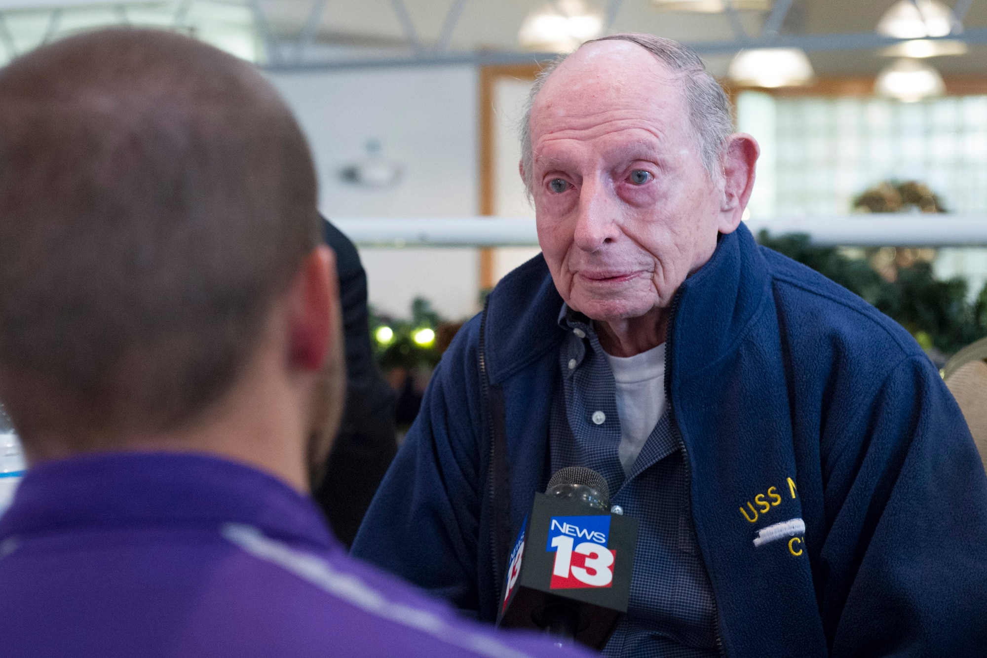 Clarence Bud Lane, a World War II veteran and Pearl Harbor survivor, speaks to a reporter about his experience 74 year ago.  Lane was one of two survivors who were honored at a ceremony hosted by the Air Force Technical Applications Center, Patrick AFB, Fla., Dec. 7, 2015.  (U.S. Air Force photo by Matthew Jurgens)