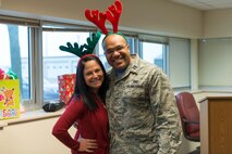 Capt. William-Joseph Mojica, 934th Airlift Wing Public Affairs Officer, and his wife Maria take part in some holiday merriment at the wing staff party. (Air Force Photo/Staff Sgt. Trevor Saylor)