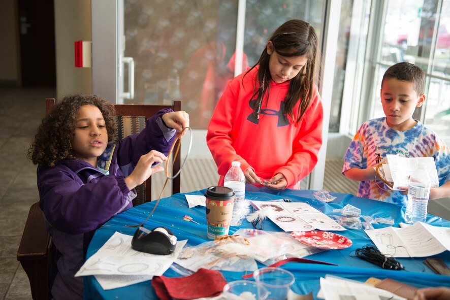 Children make holiday gifts for their parents at the Key Spouse Open House Dec. 5. (Air Force Photo/Master Sgt. Eric Amidon)