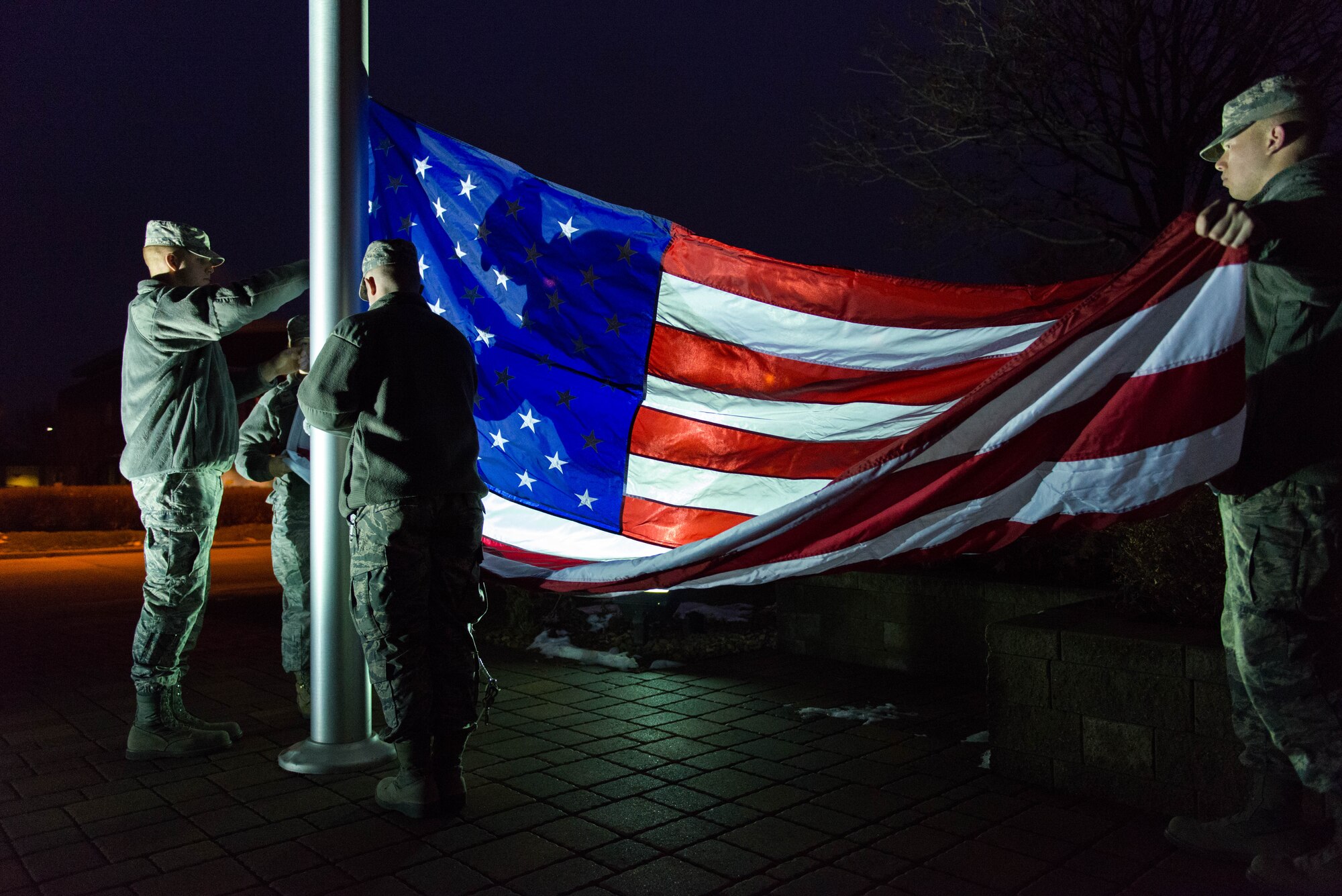 Members of the 27 Aerial Port Squadron participate in a flag raising ceremony Dec. 6 at the Minneapolis-St. Paul Air Reserve Station. (Air Force Photo/Staff Sgt. Trevor Saylor)