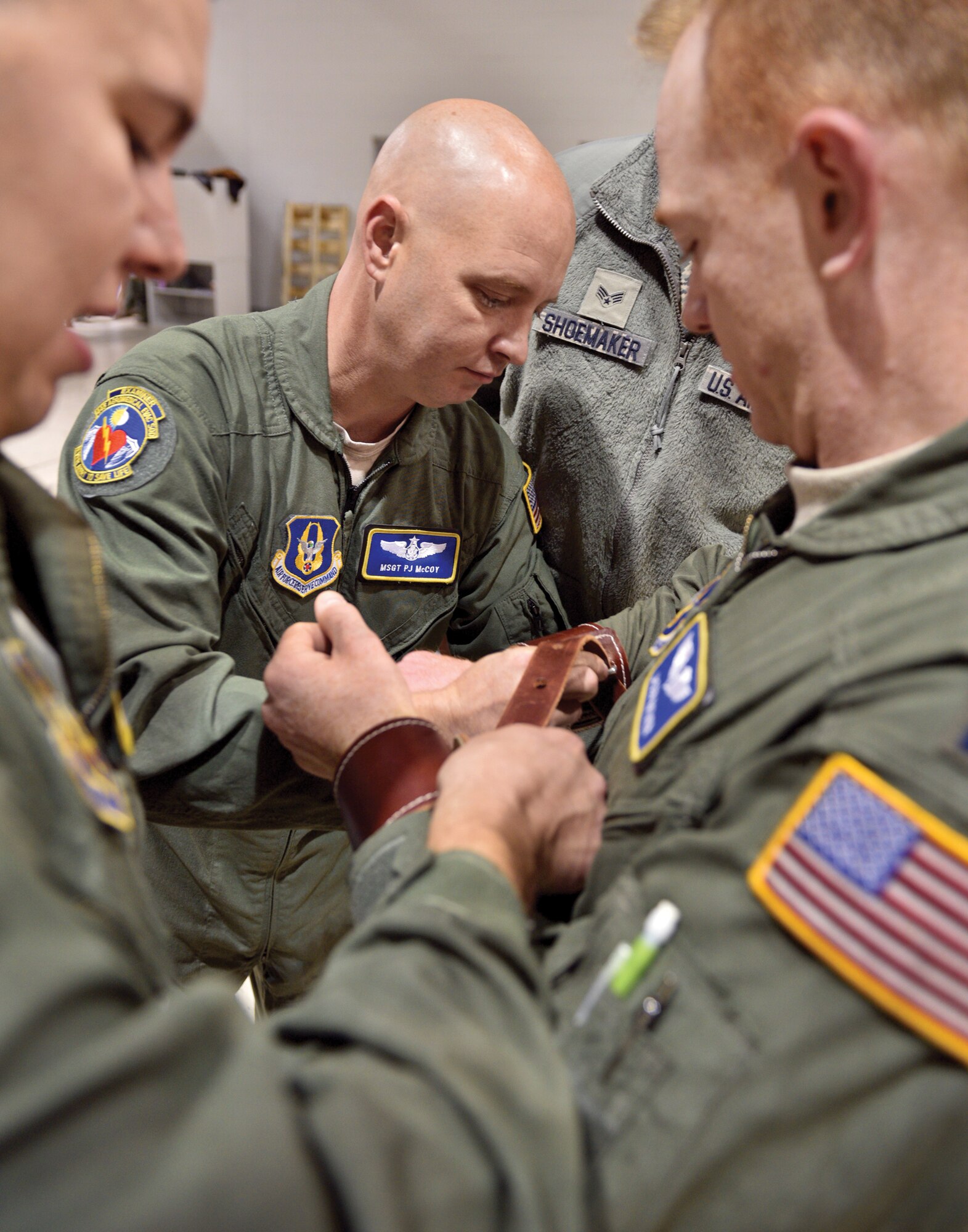 WRIGHT-PATTERSON AIR FORCE BASE, Ohio—Master Sgt. PJ McCoy, center, medical technician with the 445th Aeromedical Evacuation Squadron, and other medical personnel practice applying patient restraints to Capt. Jason Nather, a flight nurse, during the Nov. 15, 2015 unit training assembly. The members of the squadron were undergoing “Hands-on Equipment Review” with medical and other equipment used by the technicians and nurses during medical evacuation missions. The training is an annual requirement for the flyers and helps them refresh on safety while using the equipment in flight.. (U.S. Air Force photo/Tech. Sgt. Frank Oliver)