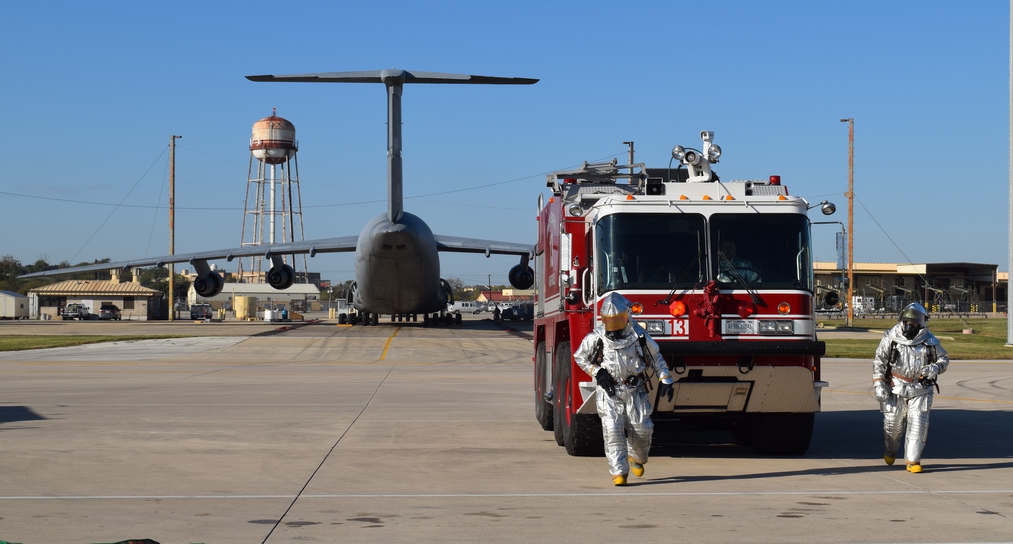 Firefighters with the 433rd Civil Engineer Squadron conduct C-5 Egress training Dec. 6, 2015 on the Joint Base San Antonio-Lackland, Texas flightline. During the training session, the firefighters responded to a simulated engine fire on a C-5A Galaxy. (U.S. Air Force photo/Tech. Sgt. Lindsey Maurice)