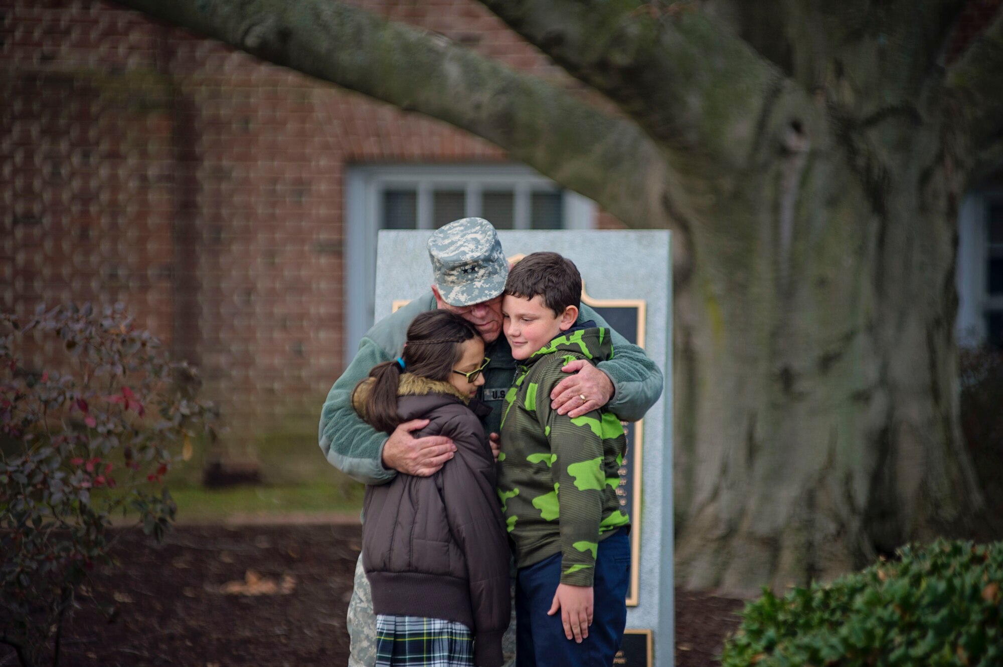Maj. Gen. Frank D. Vavala, Adjutant General for the Delaware National Guard, hugs school children from Holy Cross Elementary after laying a memorial wreath at Dover Light Infantry Memorial during the Wreaths Across America ceremony December 7 in Dover, Del. Vavala, along with Airmen and reservists from Dover Air Force Base, attended the ceremony to show support for the event. (U.S. Air Force photo/Capt. Bernie Kale)