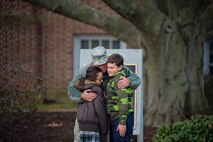Maj. Gen. Frank D. Vavala, Adjutant General for the Delaware National Guard, hugs school children from Holy Cross Elementary after laying a memorial wreath at Dover Light Infantry Memorial during the Wreaths Across America ceremony December 7 in Dover, Del. Vavala, along with Airmen and reservists from Dover Air Force Base, attended the ceremony to show support for the event. (U.S. Air Force photo/Capt. Bernie Kale)