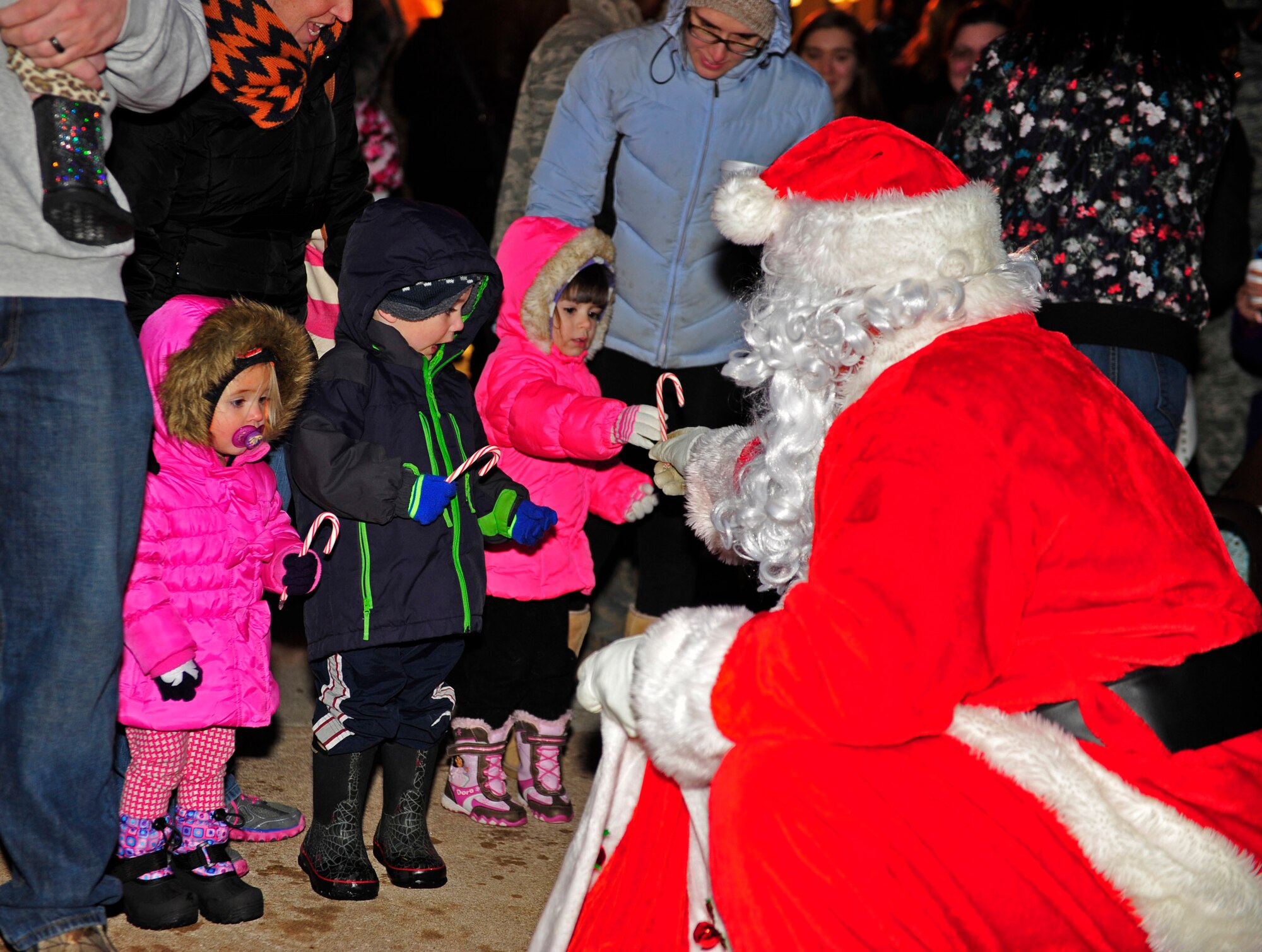 Santa delivers candy canes to children at the 28th Bomb Wing tree lighting ceremony at Ellsworth Air Force Base, S.D., Dec. 2, 2015. The 28th BW chaplain corps annually hosts this event, which provides Airmen and their families a chance to celebrate the holiday season with their military community. (U.S. Air Force photo by Airman 1st Class James L. Miller/Released)
