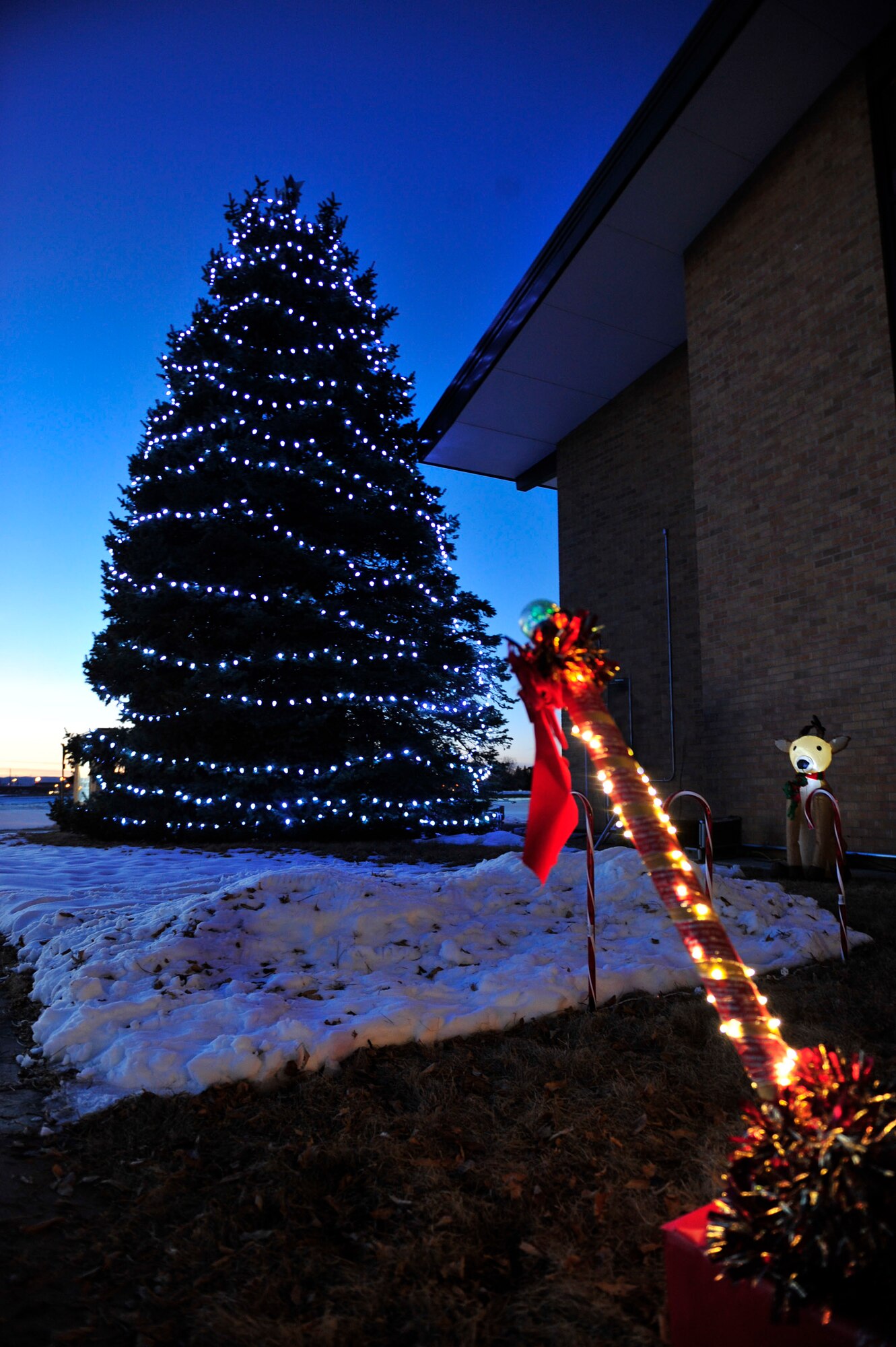 The Freedom Chapel Christmas tree illuminates the night at Ellsworth Air Force Base, S.D., Dec. 2, 2015. The lights were switched on by children of deployed Airmen during the 28th Bomb Wing tree lighting ceremony. (U.S. Air Force photo by Airman 1st Class James L. Miller/Released)