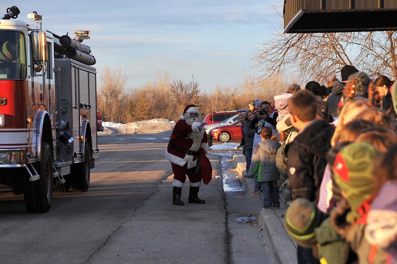 Santa Claus greets children at the Northern Lights Club for the Holiday Tree Lighting ceremony on Grand Forks Air Force Base, North Dakota, Dec. 7, 2015. Along with the visit from Santa, the event consisted of carols and ornament creating. (U.S. Air Force photo by Senior Airman Bonnie Grantham/released)