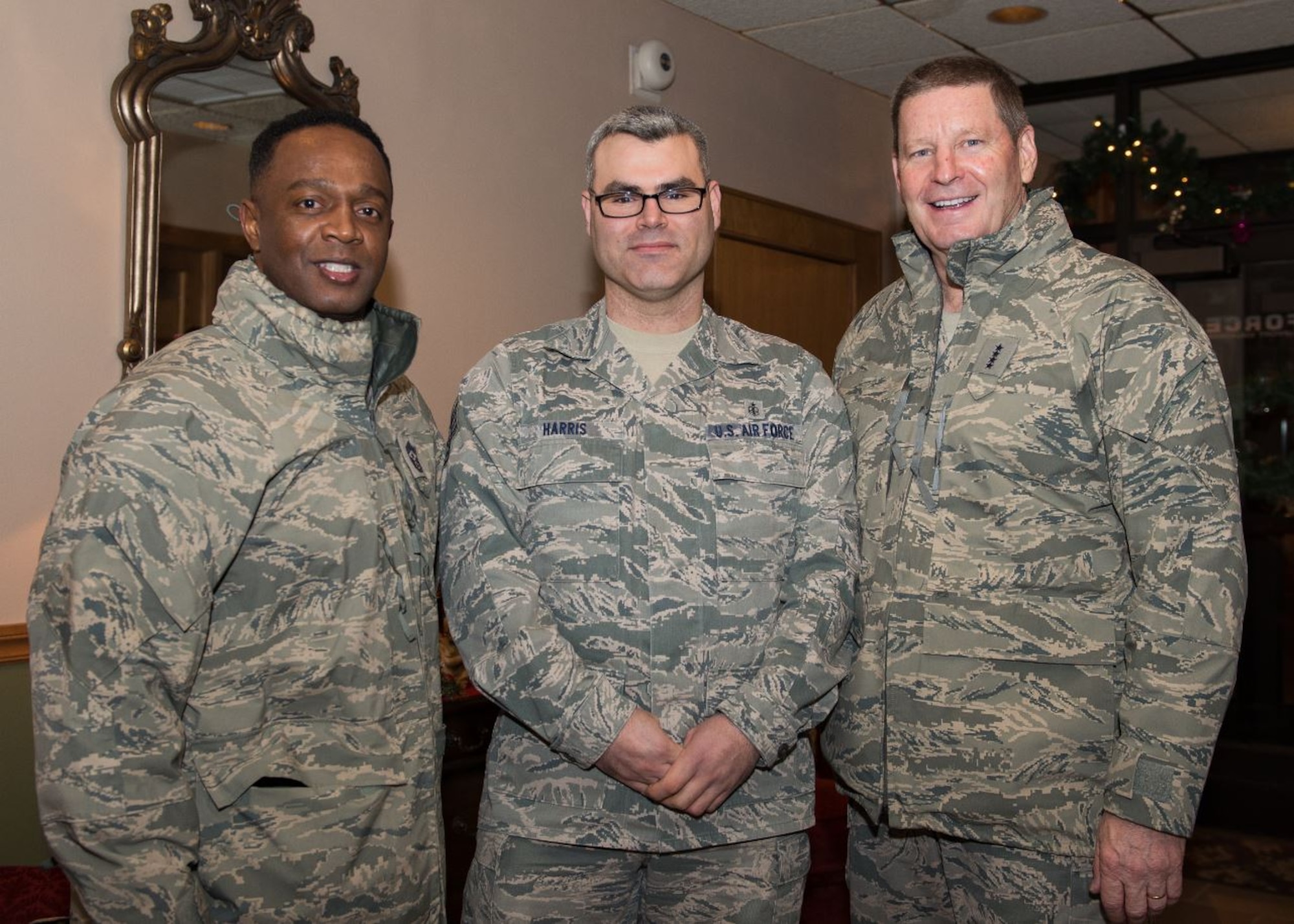 Gen. Robin Rand, AFGSC commander, and Chief Master Sgt. Calvin Williams, AFGSC command chief, recognize Tech. Sgt. Sergio Harris, 5th Medical Support Squadron staff NCO in charge of the resource management office, at Minot AFB, North Dakota. Rand and Williams visited Team Minot Nov. 30 - Dec. 2. (U.S. Air Force photo/Airman 1st Class J.T. Armstrong)